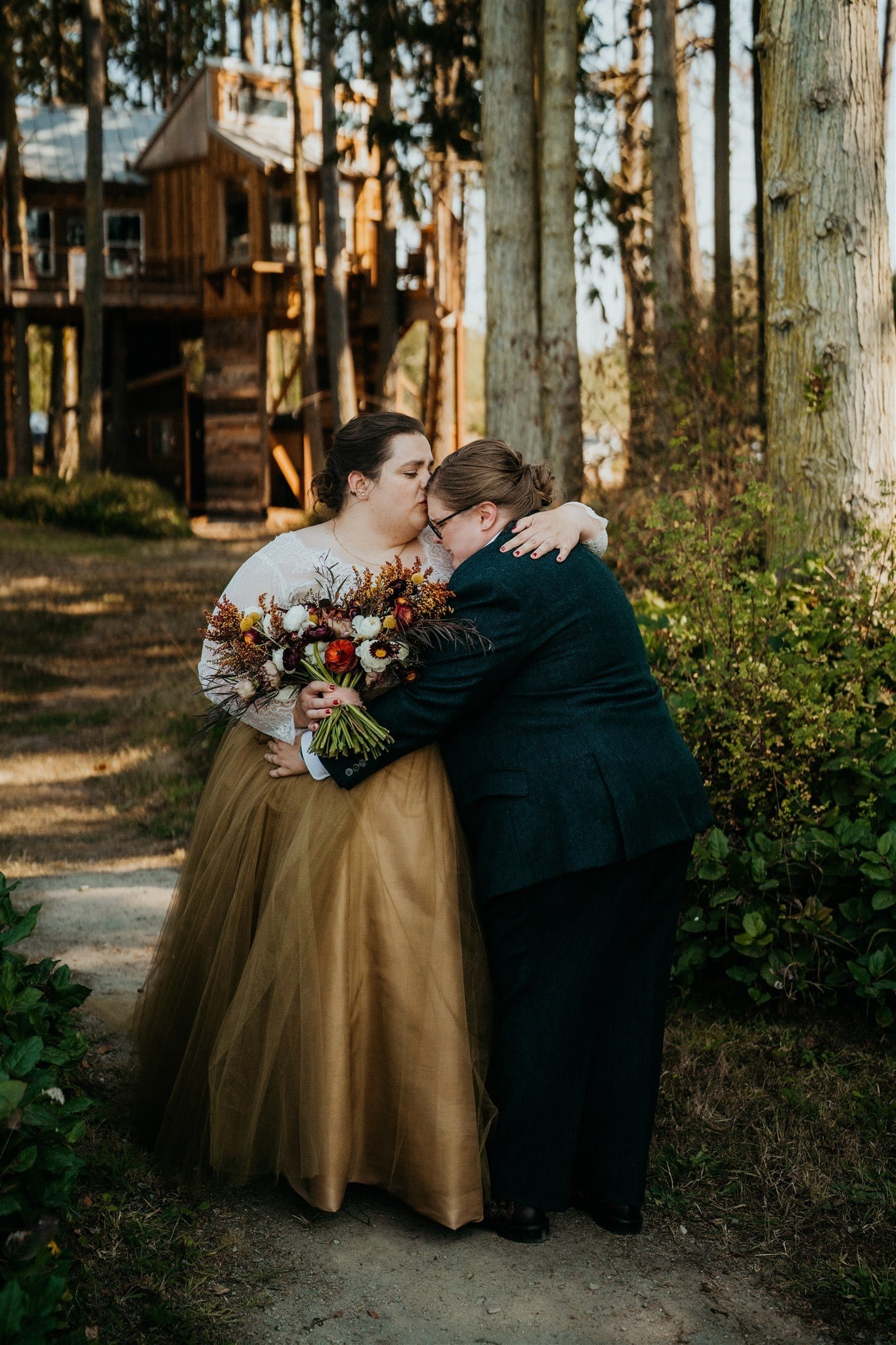 Brides hug and get emotional after first look in the forest in Olympic National Park