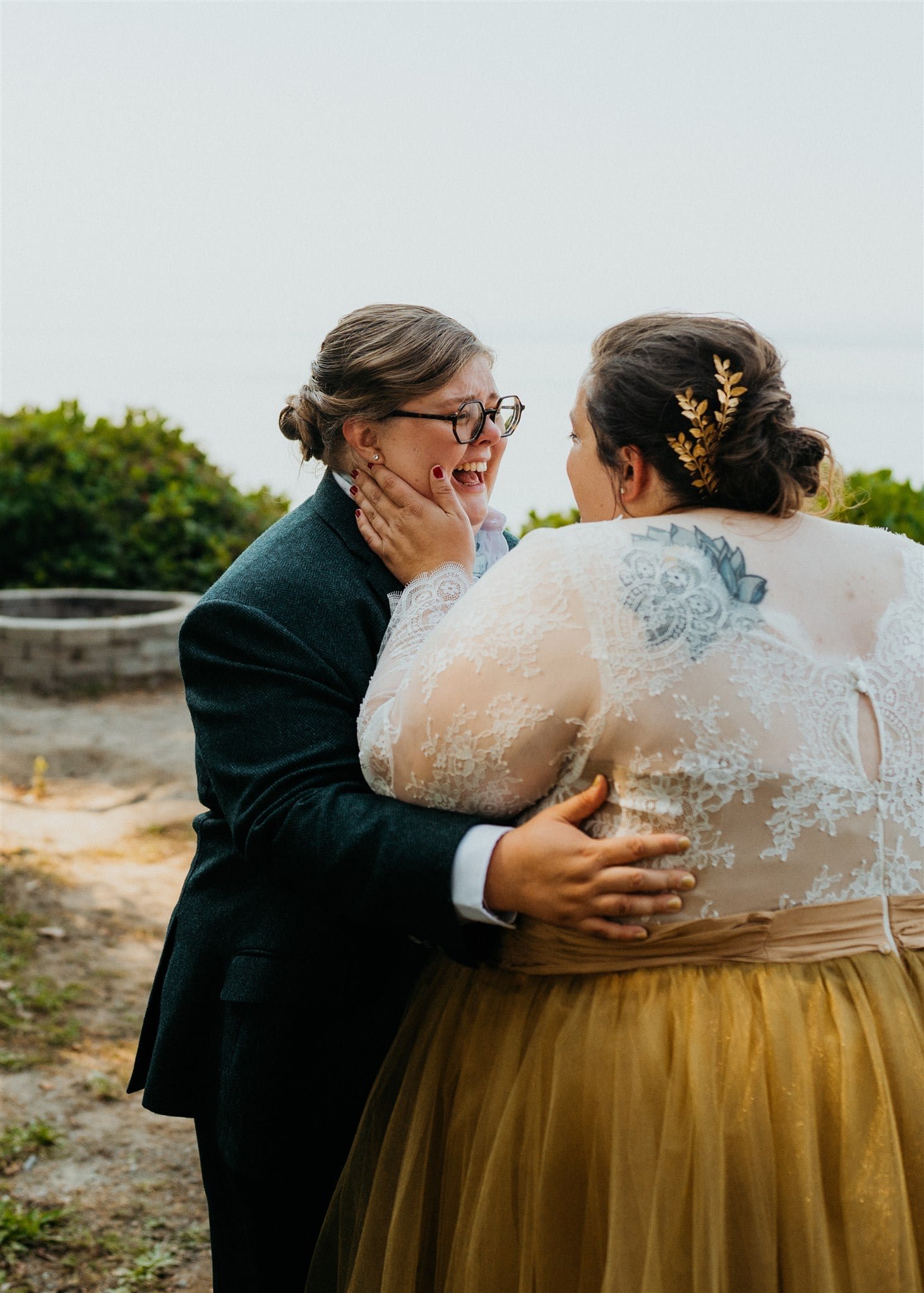 Brides hug and get emotional after first look in the forest in Olympic National Park