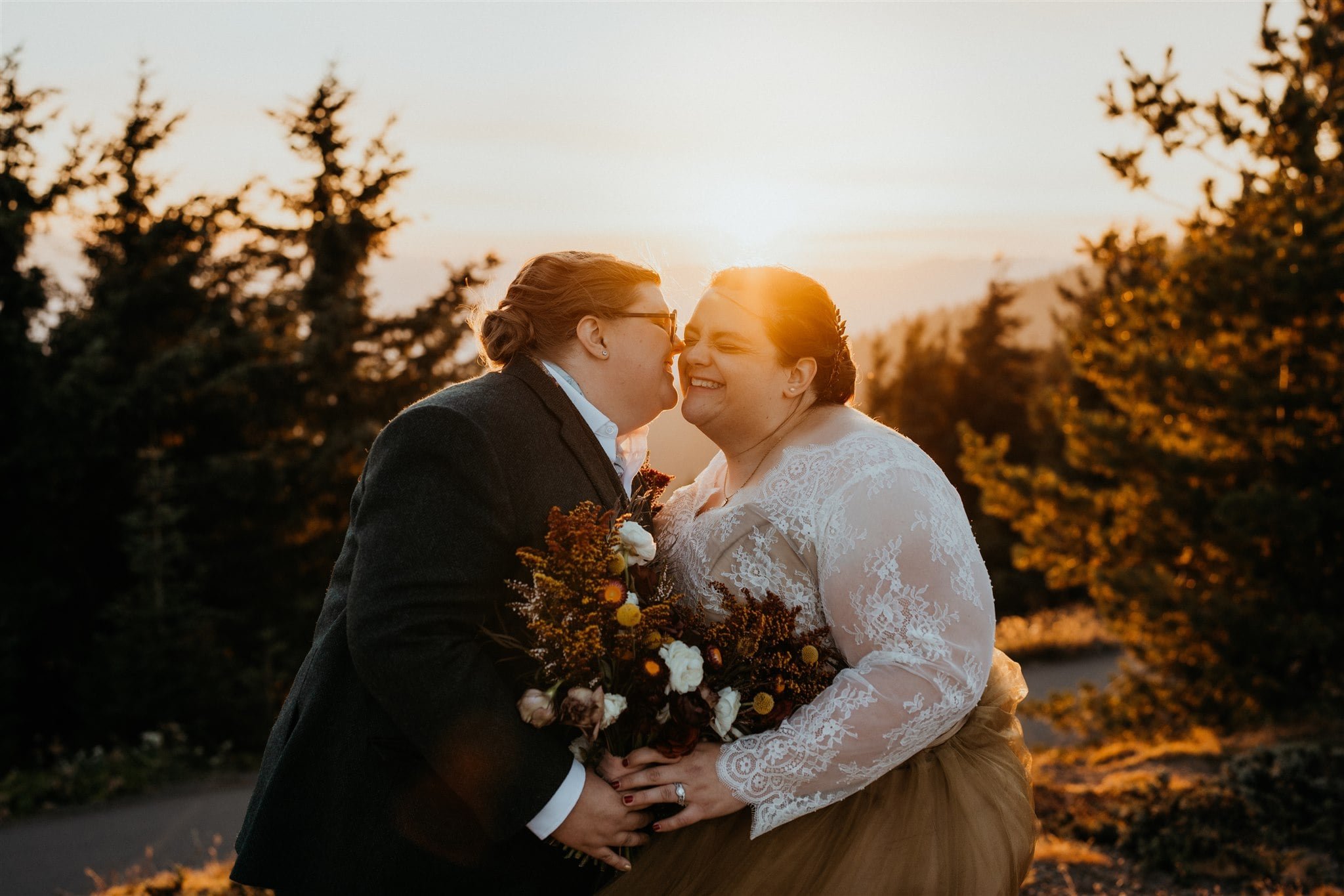 Brides kiss during sunset portraits at Olympic National Park