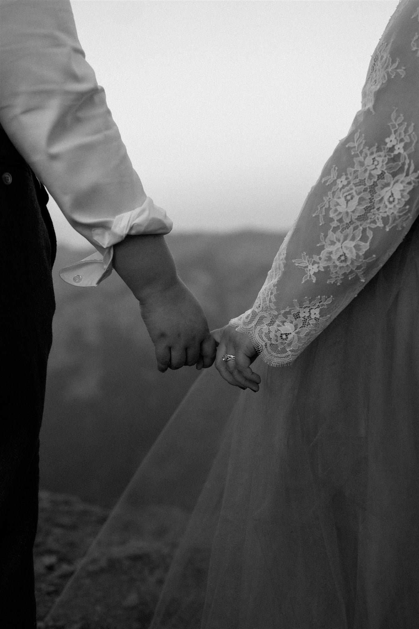 Brides hold hands during sunset photos in Olympic National Park