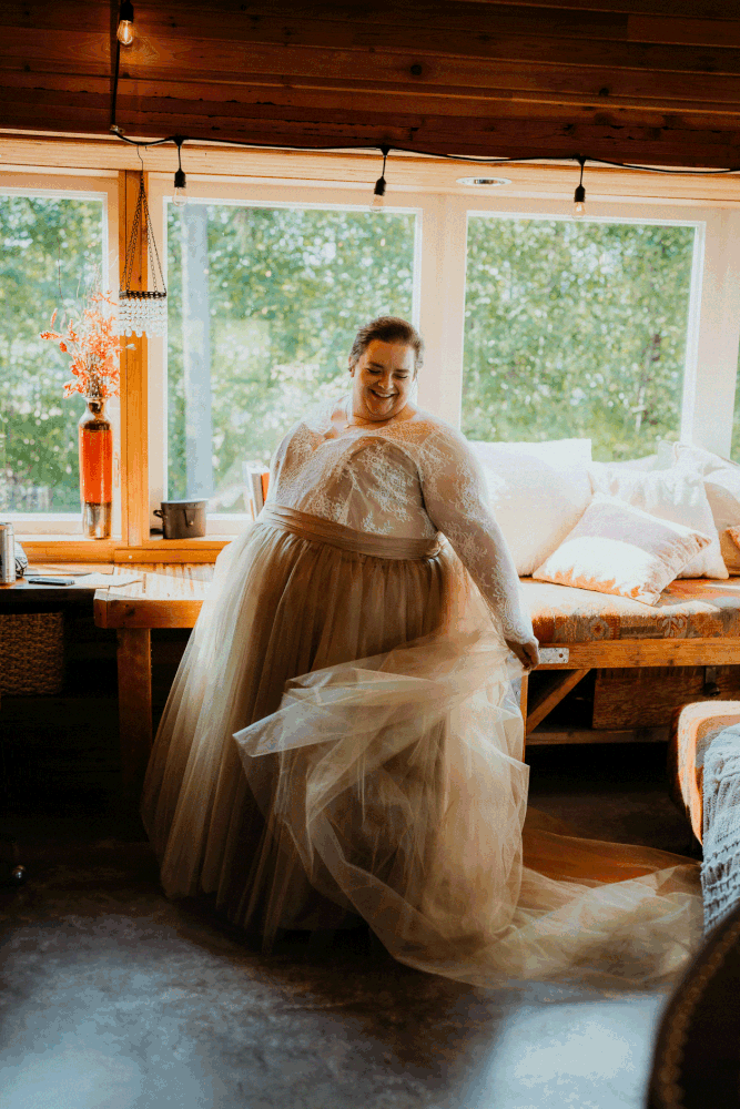 Bride twirling in white and gold wedding dress in a cabin in Olympic National Park