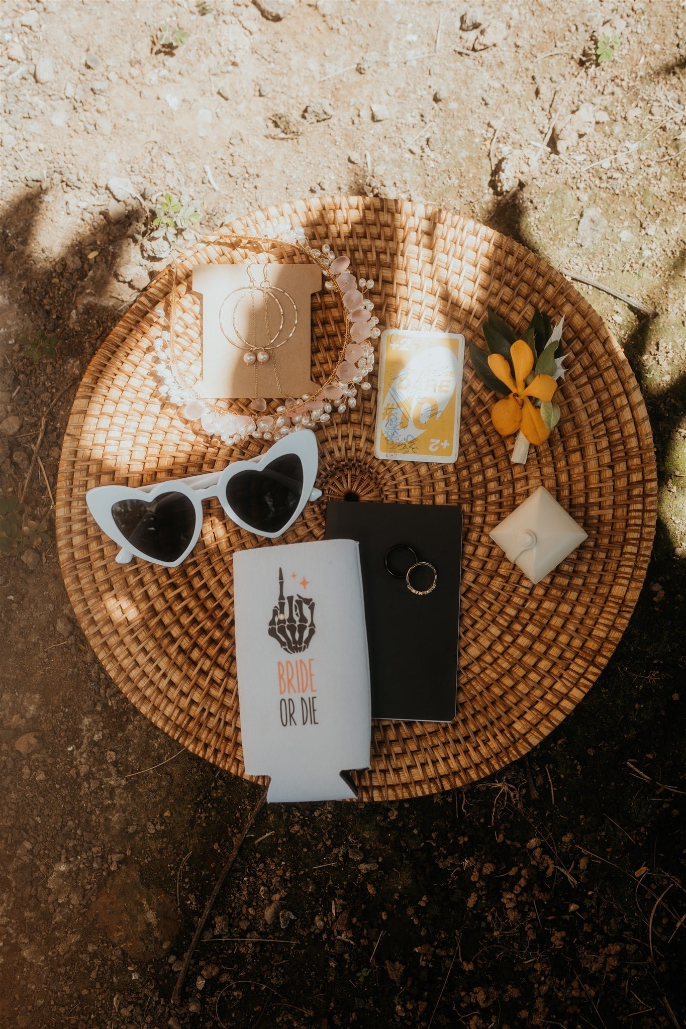 Elopement details with white heart sunglasses and black and white vow books