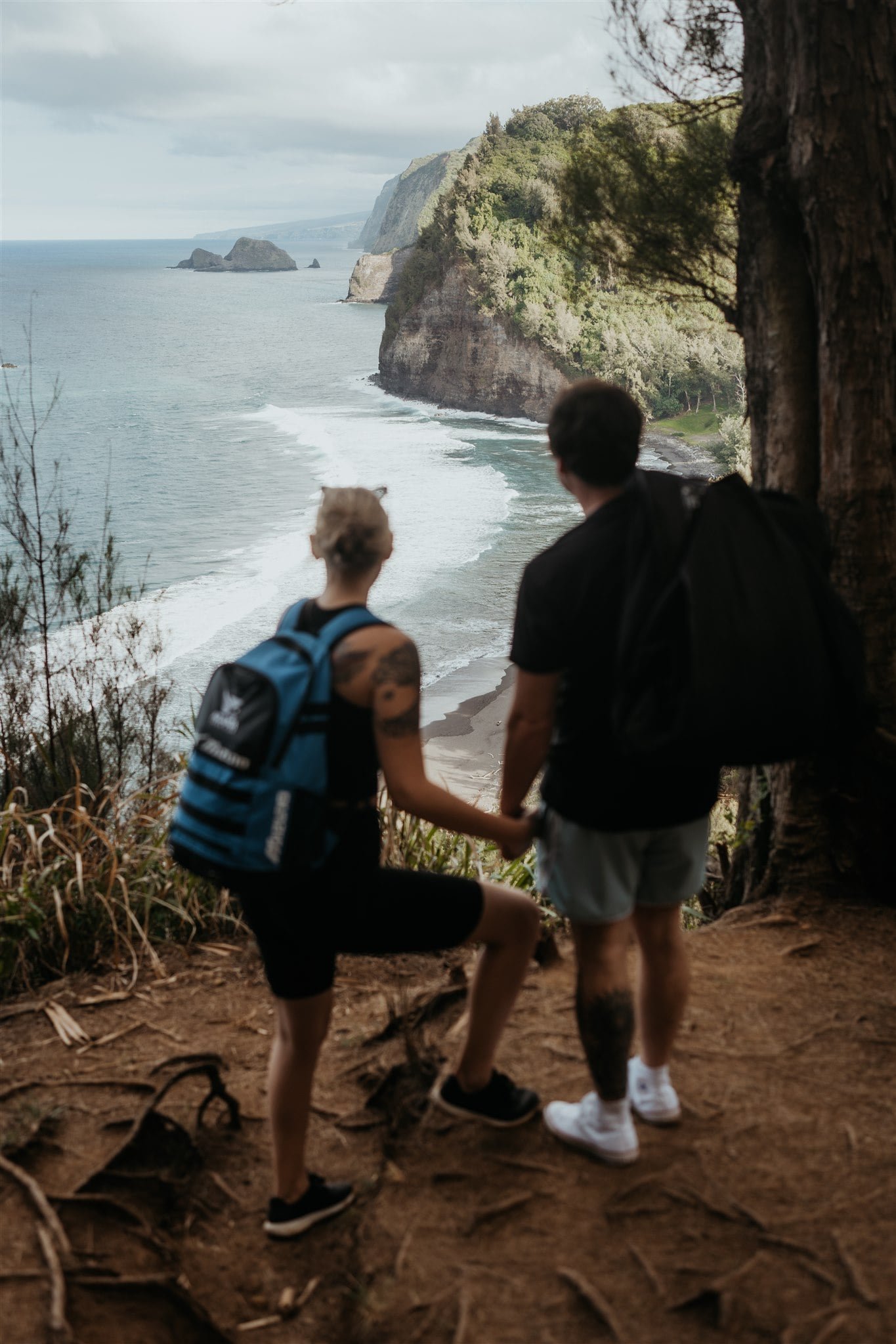 Couple stands looking out at the ocean before their Big Island elopement ceremony