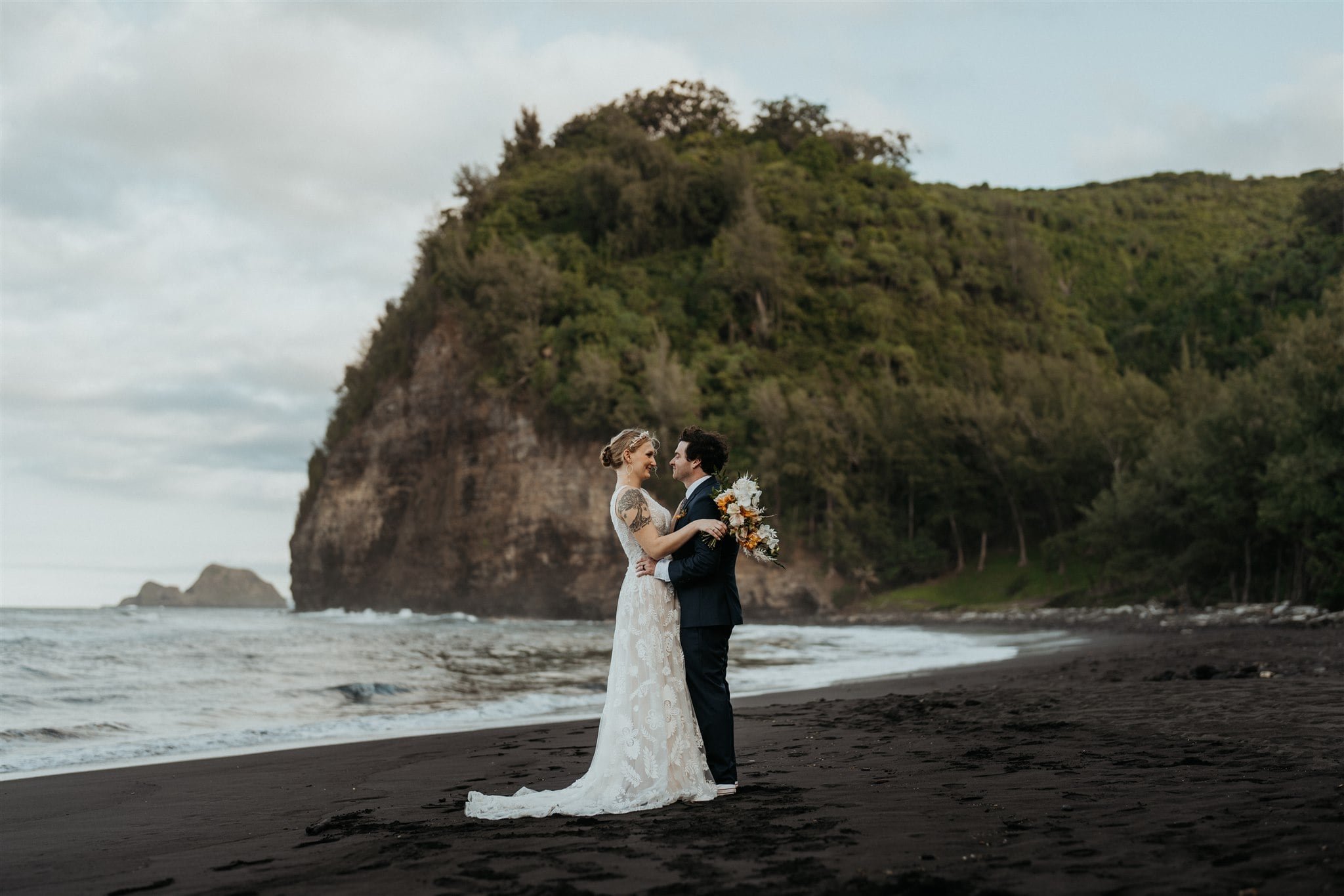 Bride and groom couple portraits on the black sand beach at their Big Island elopement