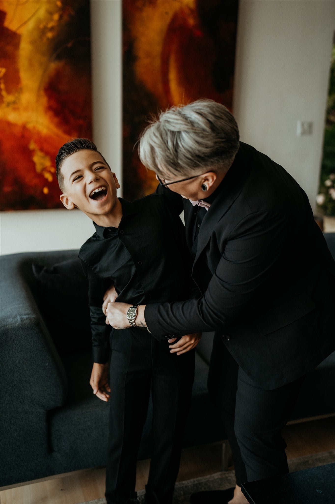 Bride hugging son and laughing while getting ready for pacific northwest elopement