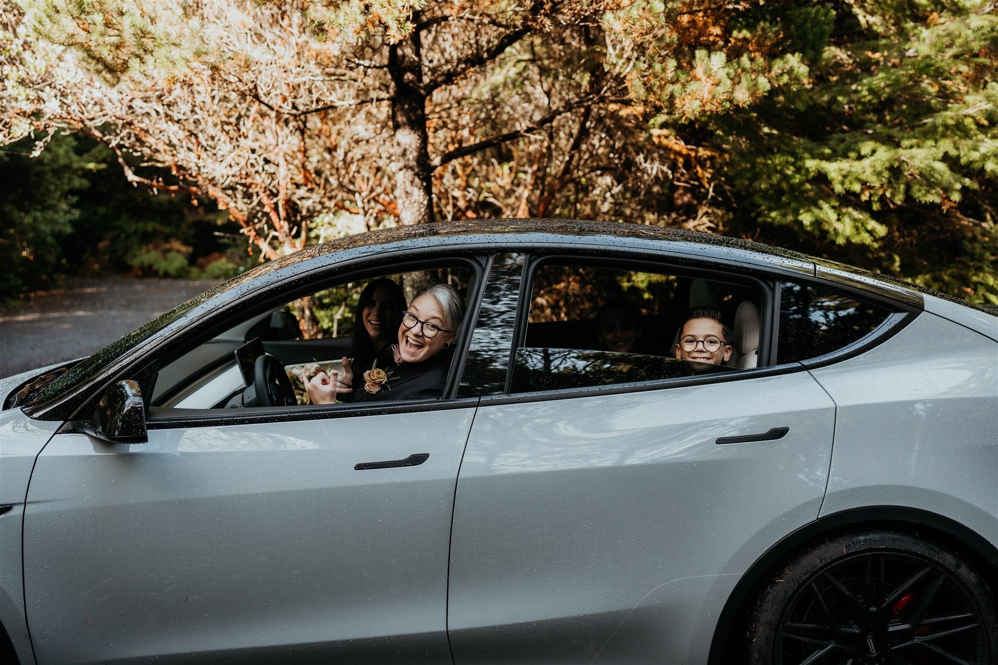 Family driving in the car on their way to their pacific northwest elopement on the beach