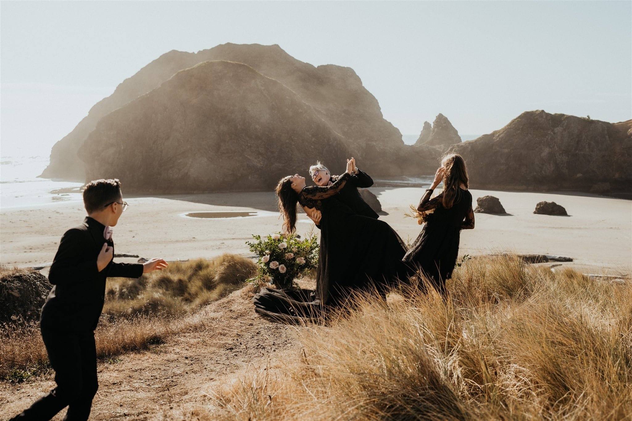 Brides dip for a kiss and laugh after their Pacific Northwest elopement ceremony 