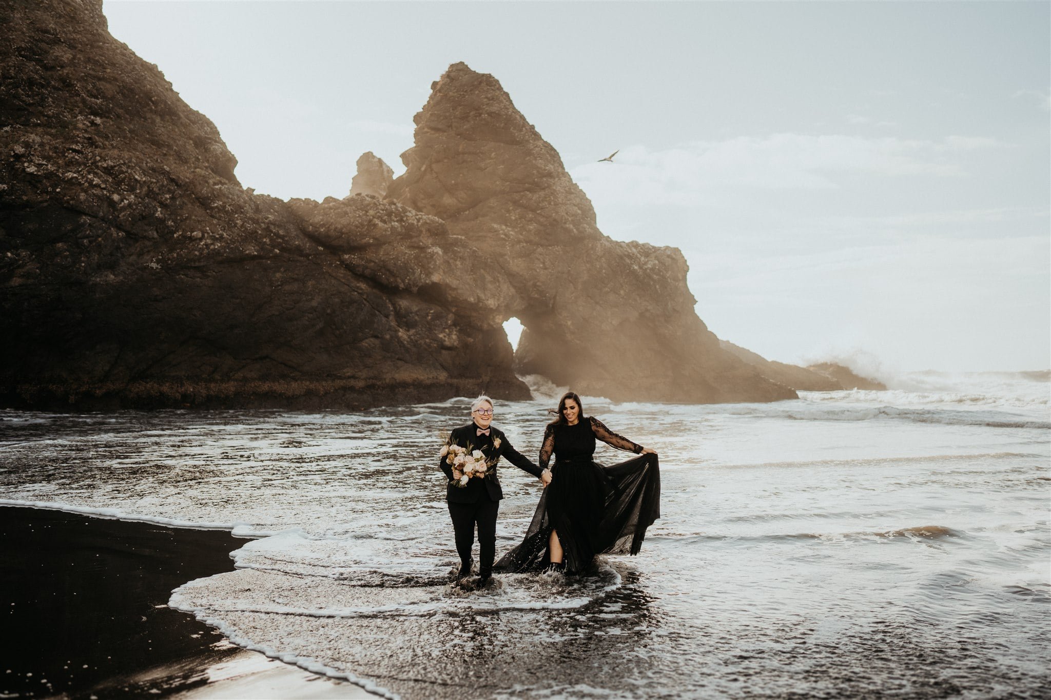 Pacific Northwest elopement on the Oregon Coast with two brides in all black wedding outfits