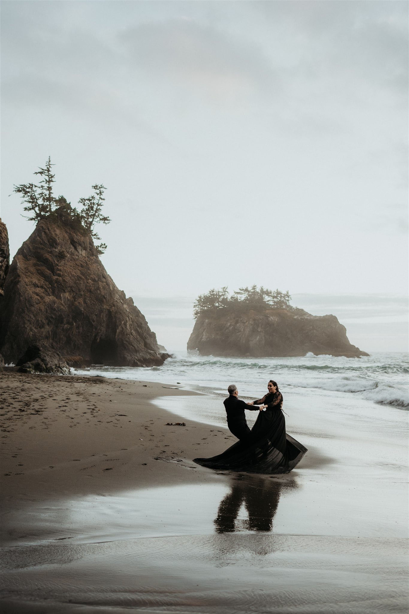 Two brides dance on the beach during Pacific Northwest elopement