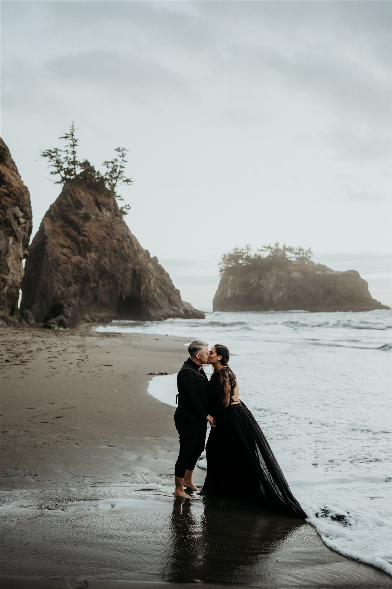 Two brides kiss on the beach during Pacific Northwest elopement