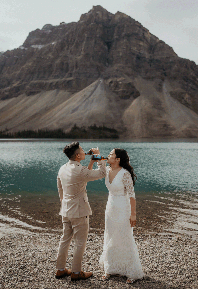 Bride and groom take shots after their elopement ceremony in Banff National Park
