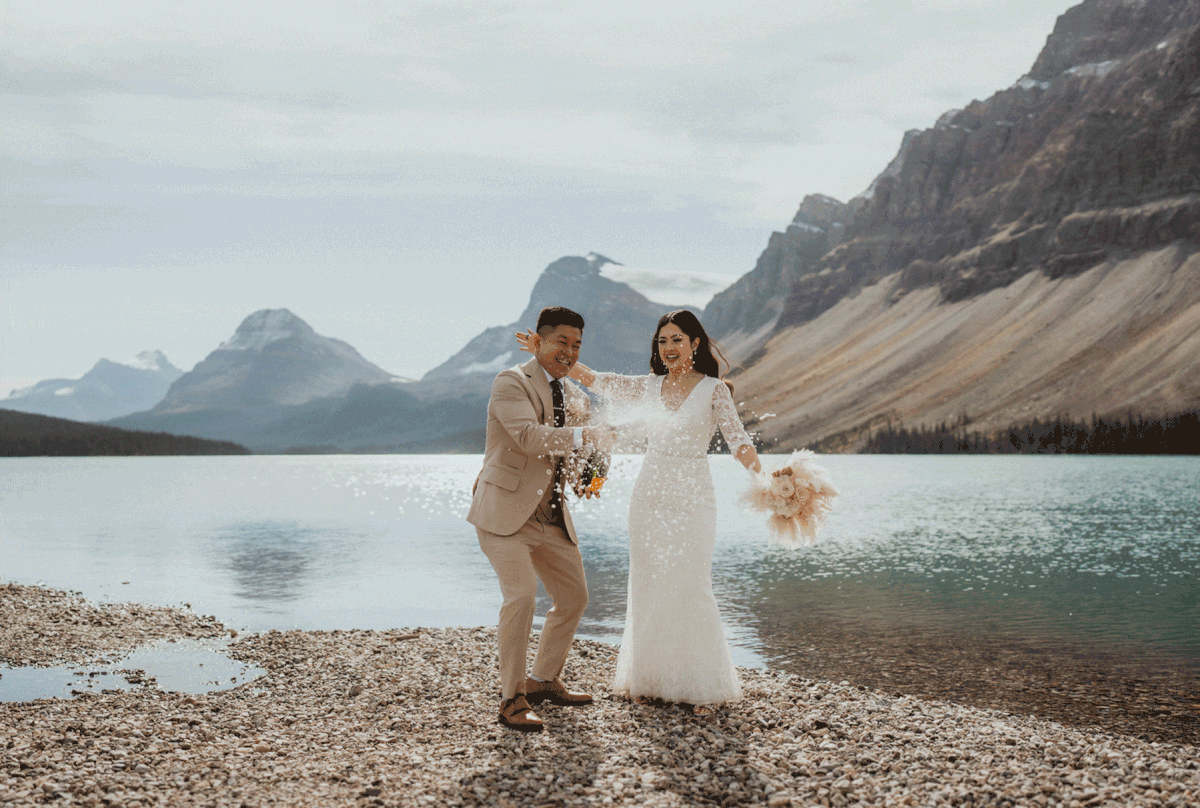 Bride and groom pop champagne during their Banff National Park elopement