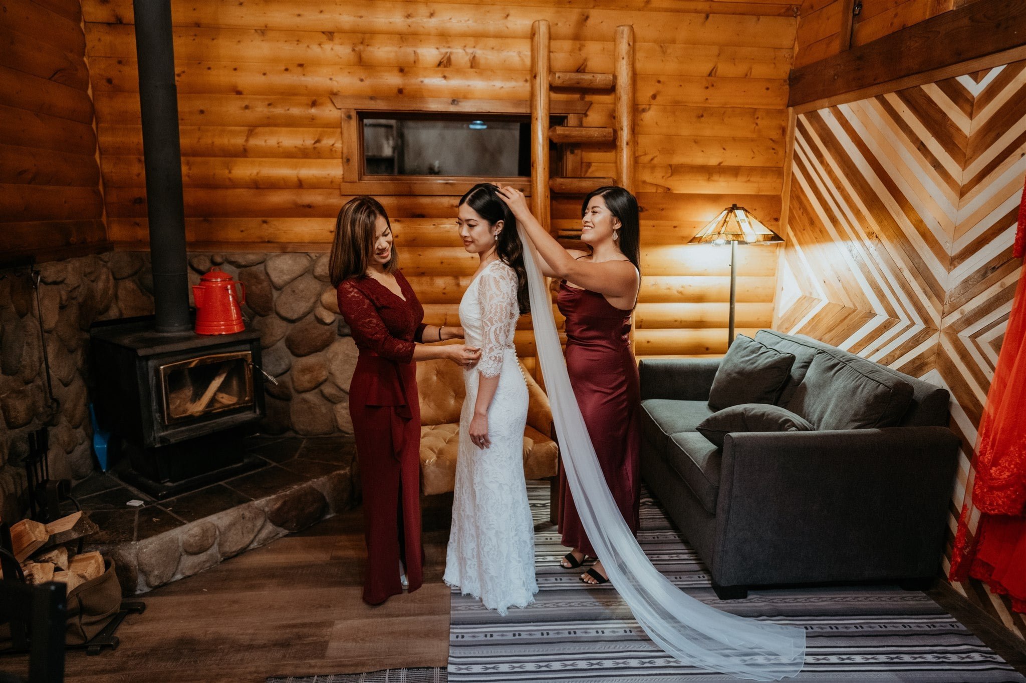 Family helping bride get ready in a cabin