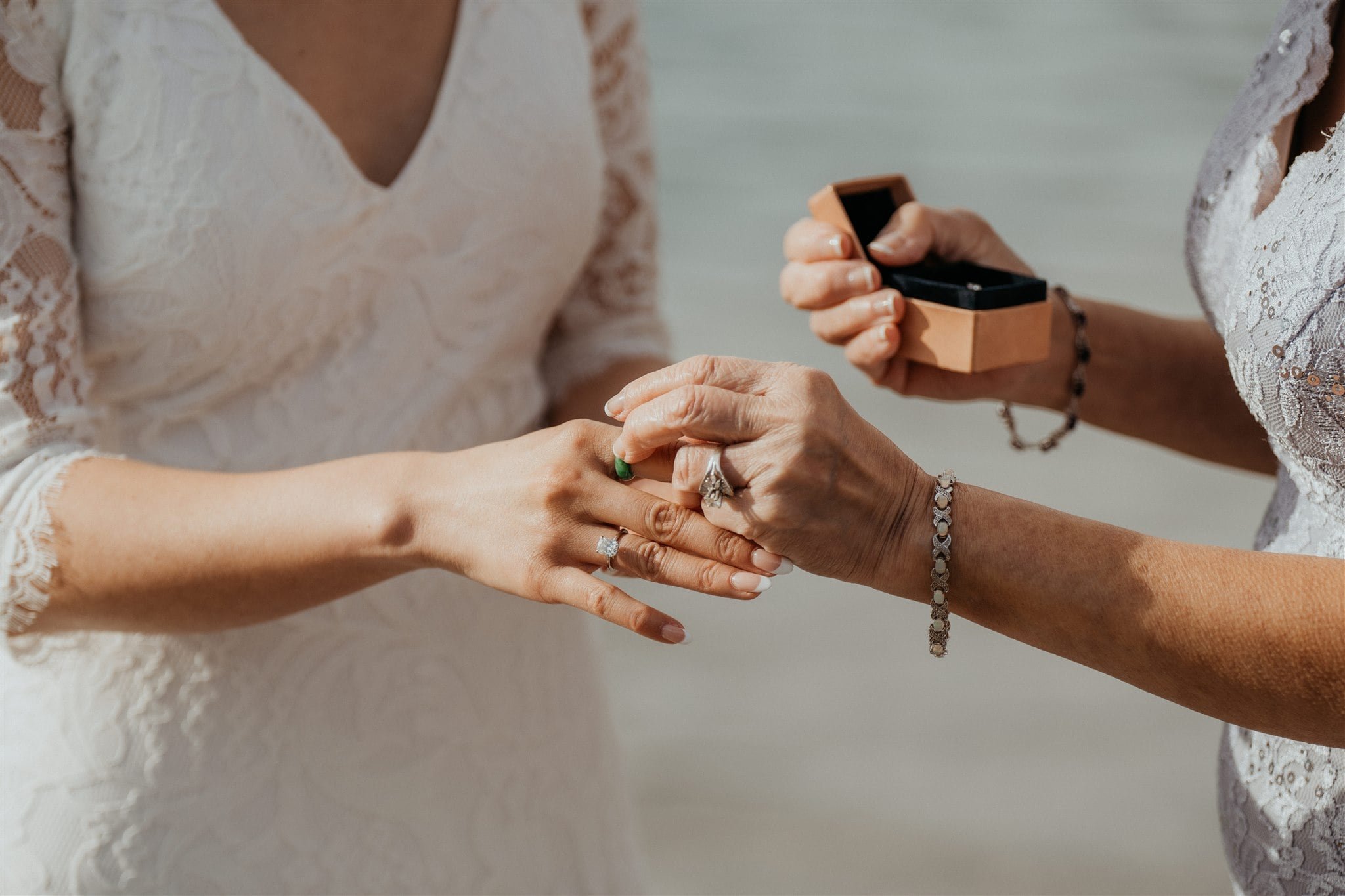 Mother of the bride gives a gift to the bride during her elopement in Banff