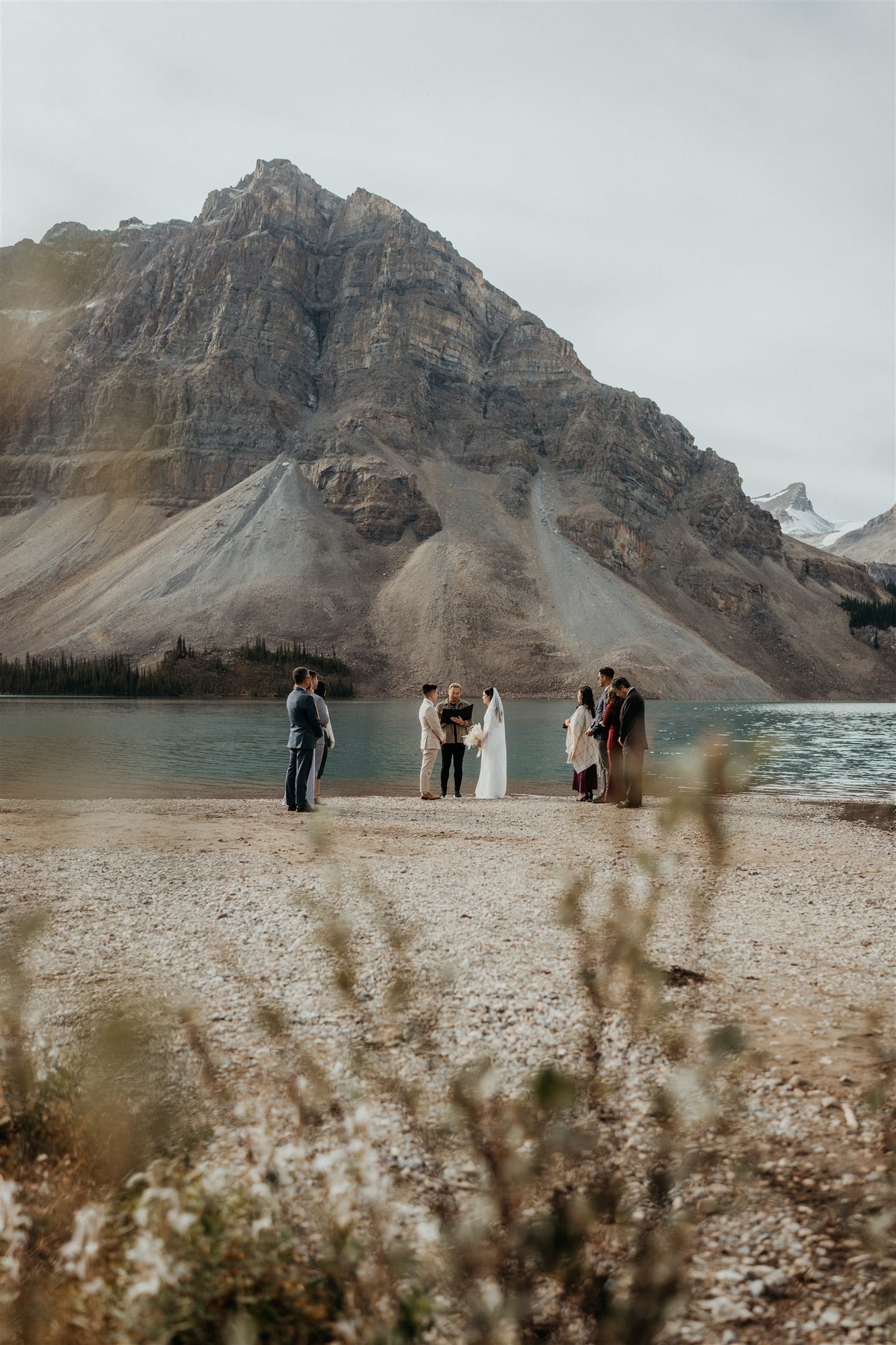 Bride and groom exchange vows at their Banff National Park elopement ceremony with guests