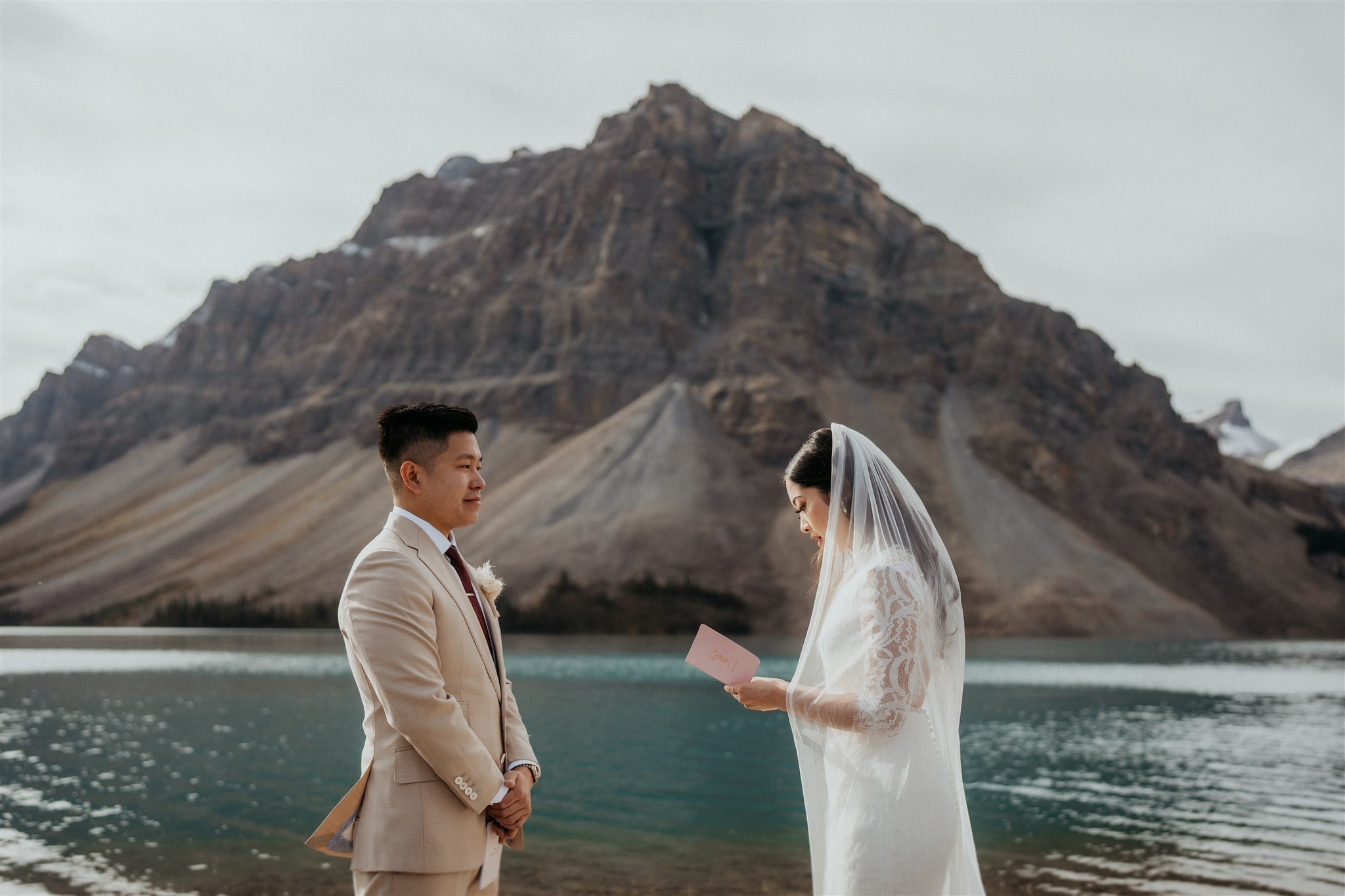 Bride and groom exchange vows at their outdoor intimate wedding ceremony in Banff National Park