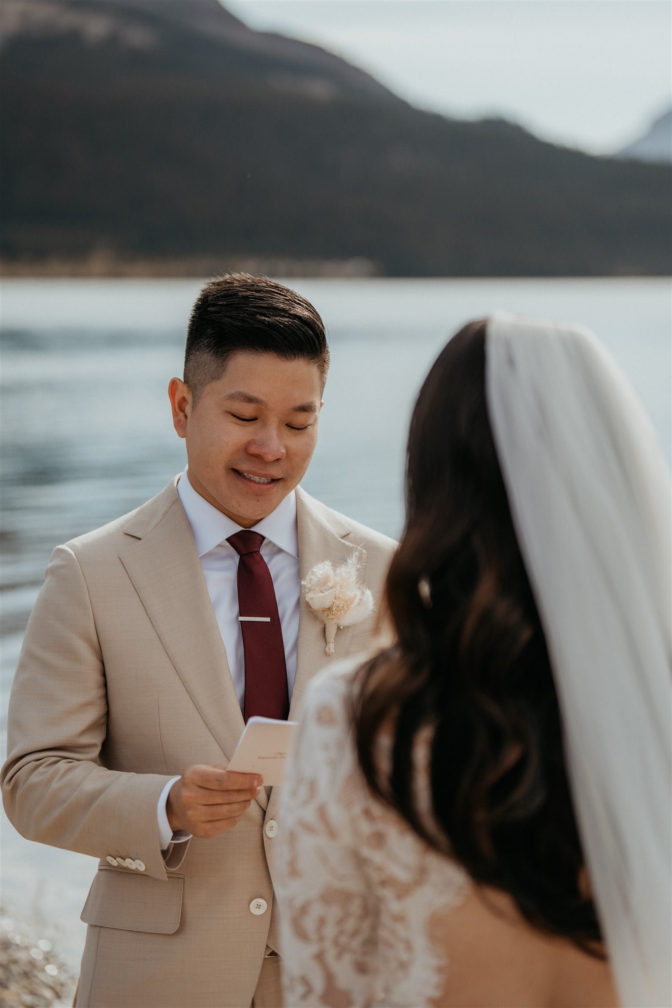 Bride and groom exchange vows at their outdoor intimate wedding ceremony in Banff National Park