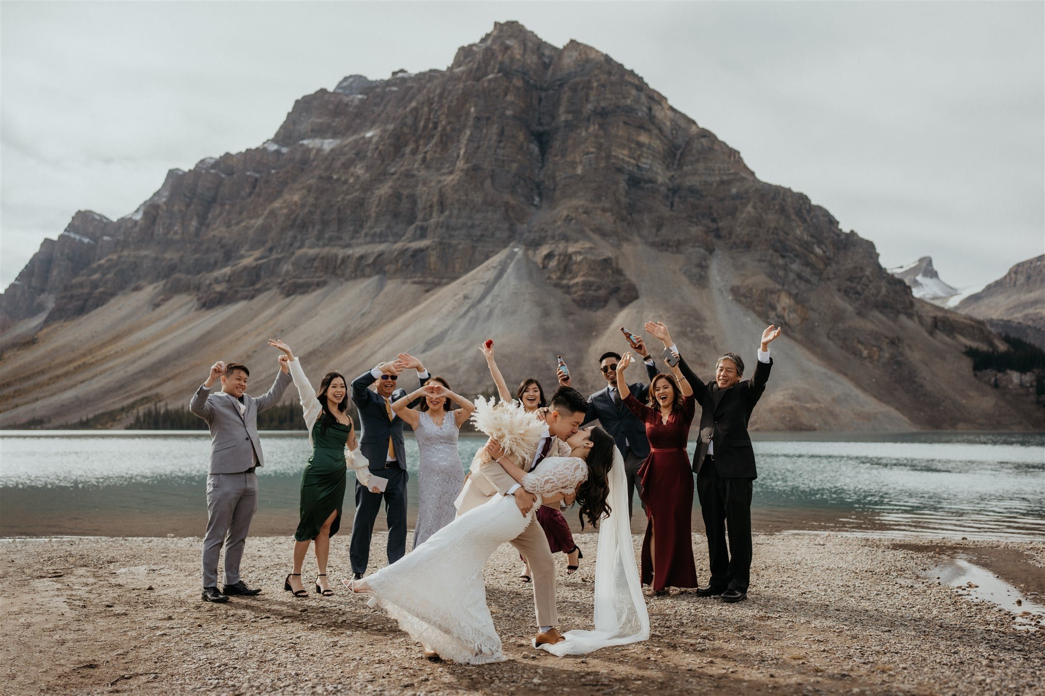 Groom dips bride for a kiss at elopement in Banff