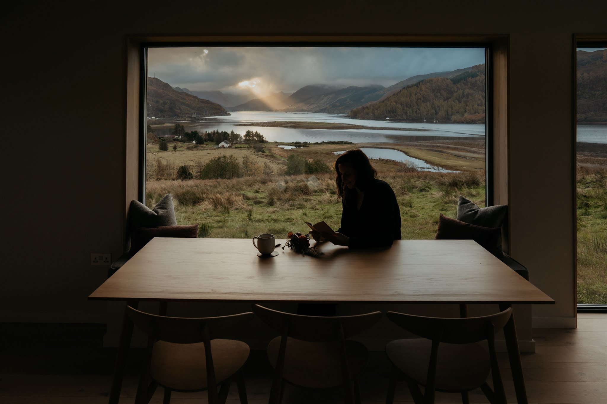 Bride sitting at Airbnb writing personal vows for elopement on the Isle of Skye