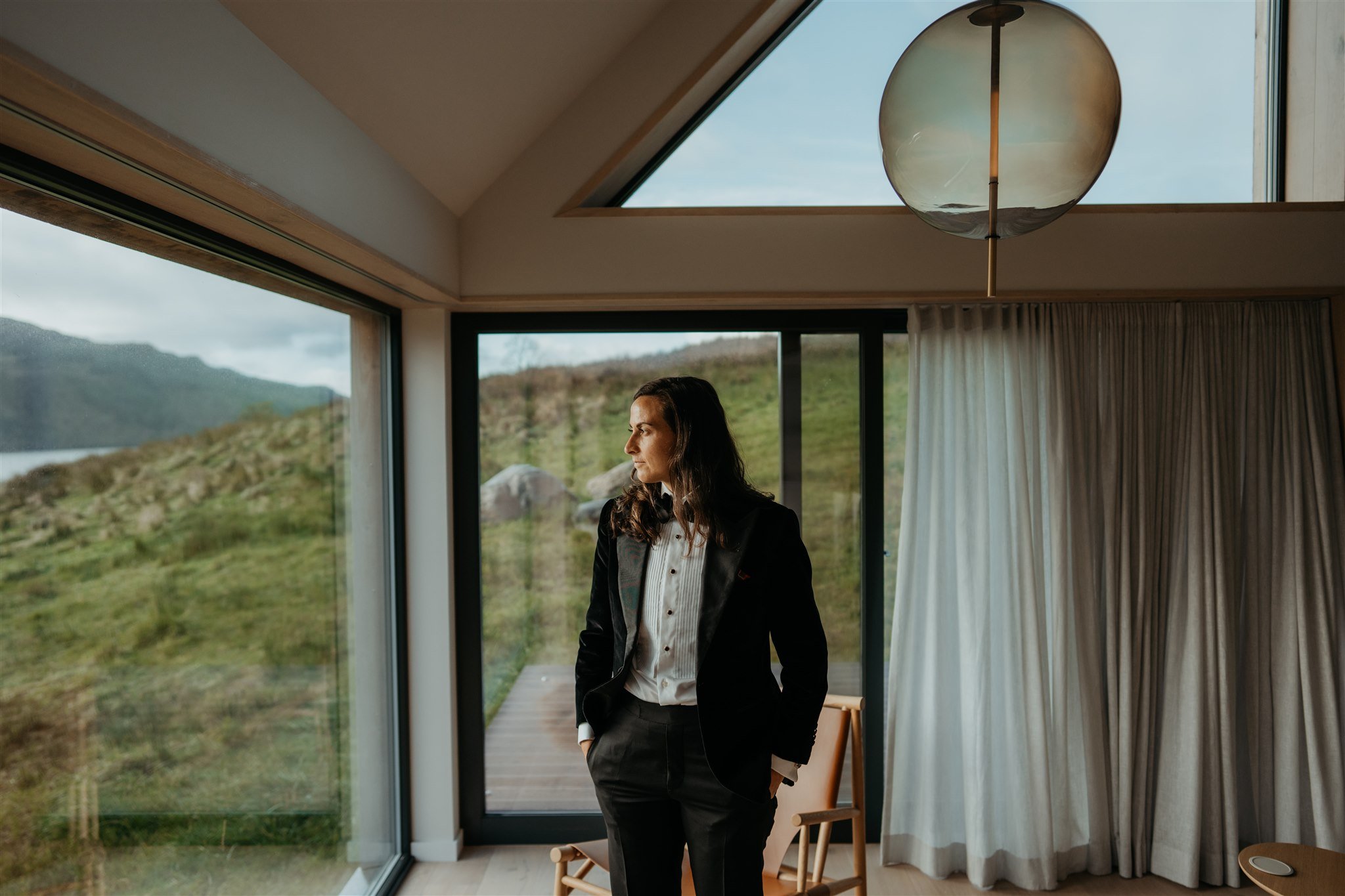 Bride looking out the window of Airbnb in Isle of Skye