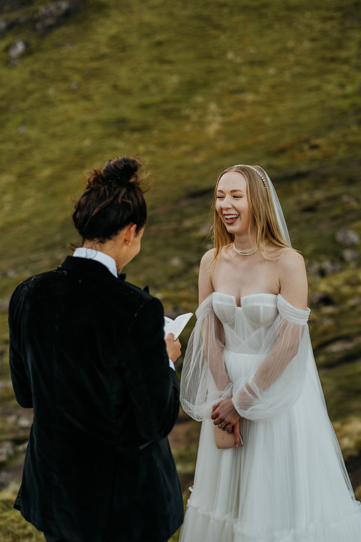 Brides laugh while exchanging vows at their Isle of Skye elopement