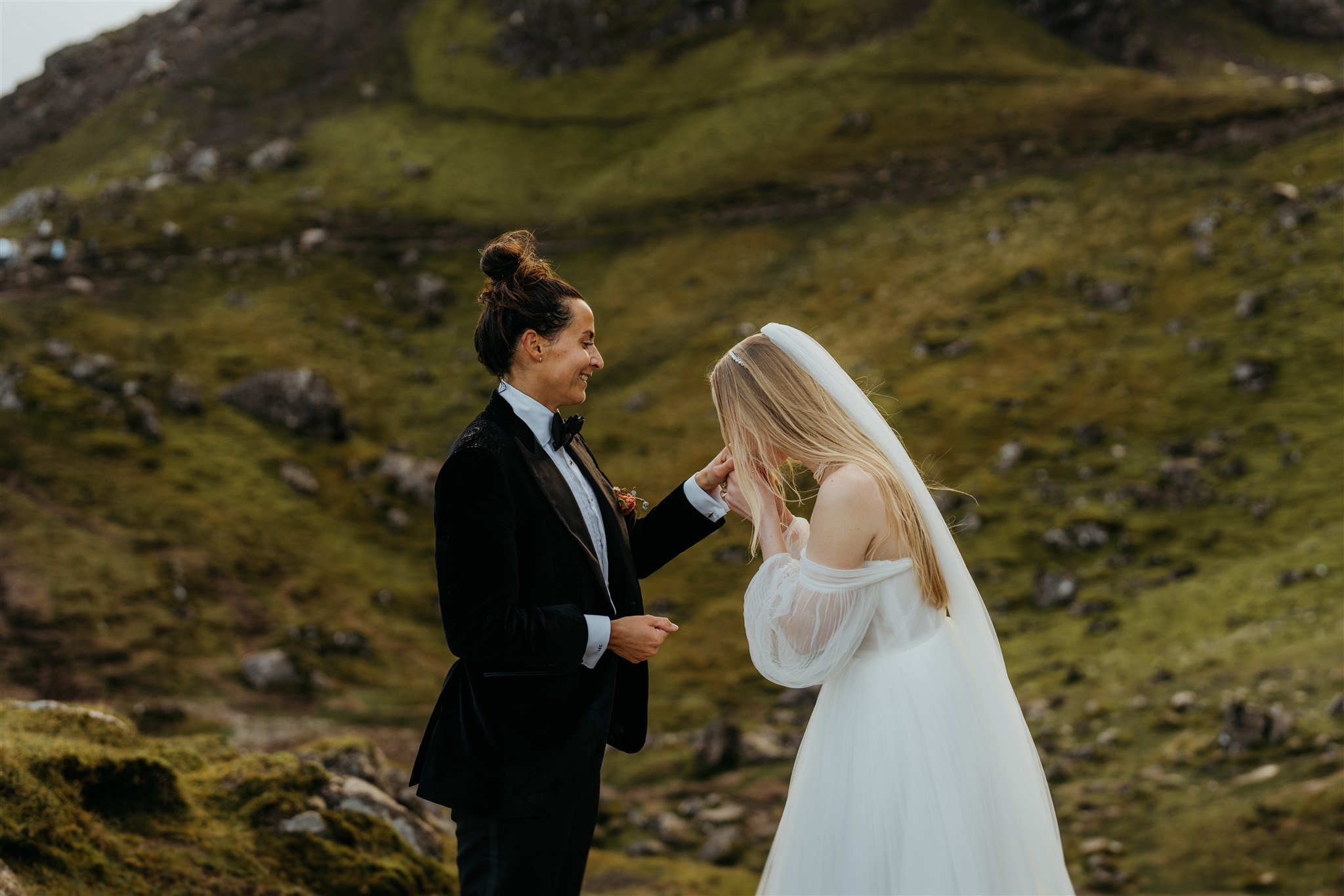 Bride kisses her wife's hand during elopement in Scotland