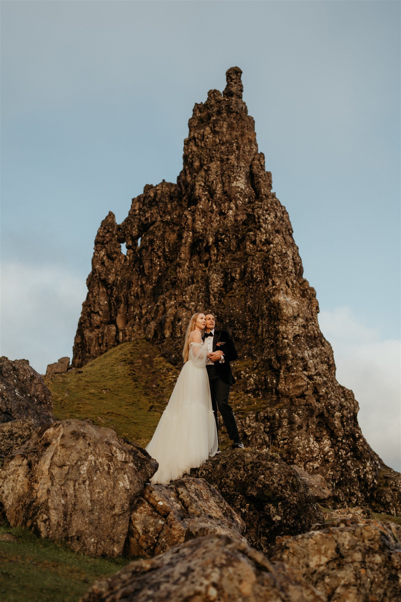 Brides hold each other during adventure elopement photos on the Isle of Skye