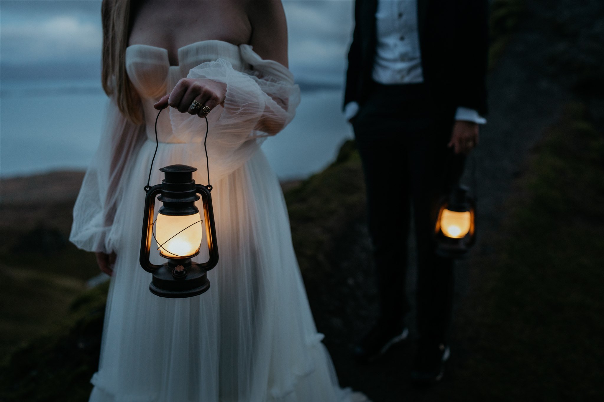 Brides holding lanterns during blue hour elopement photos 