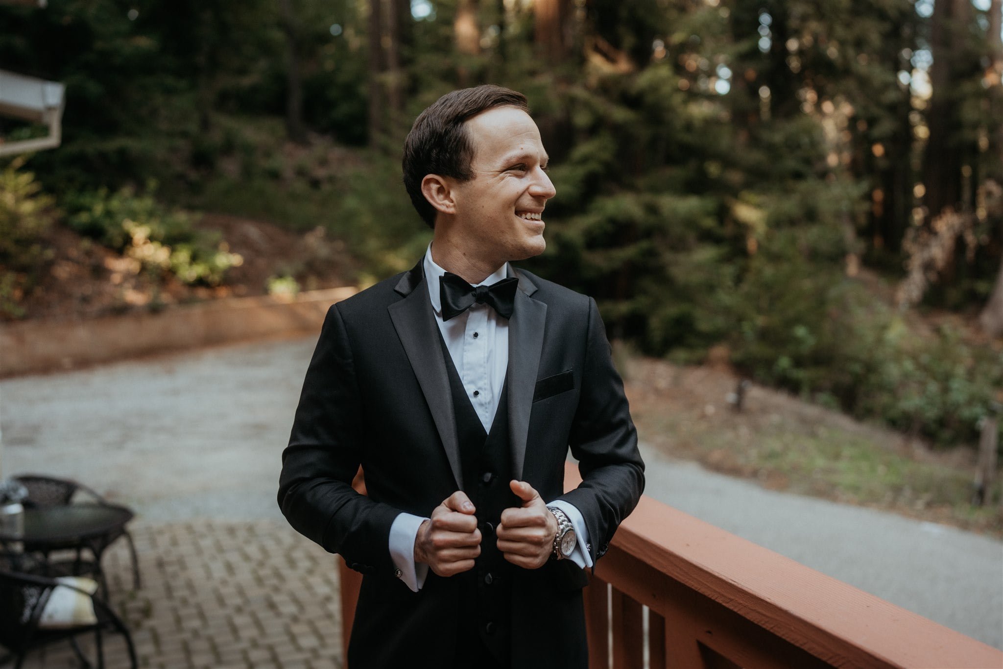 Groom wearing black tux for winter wedding at Sequoia Retreat Center