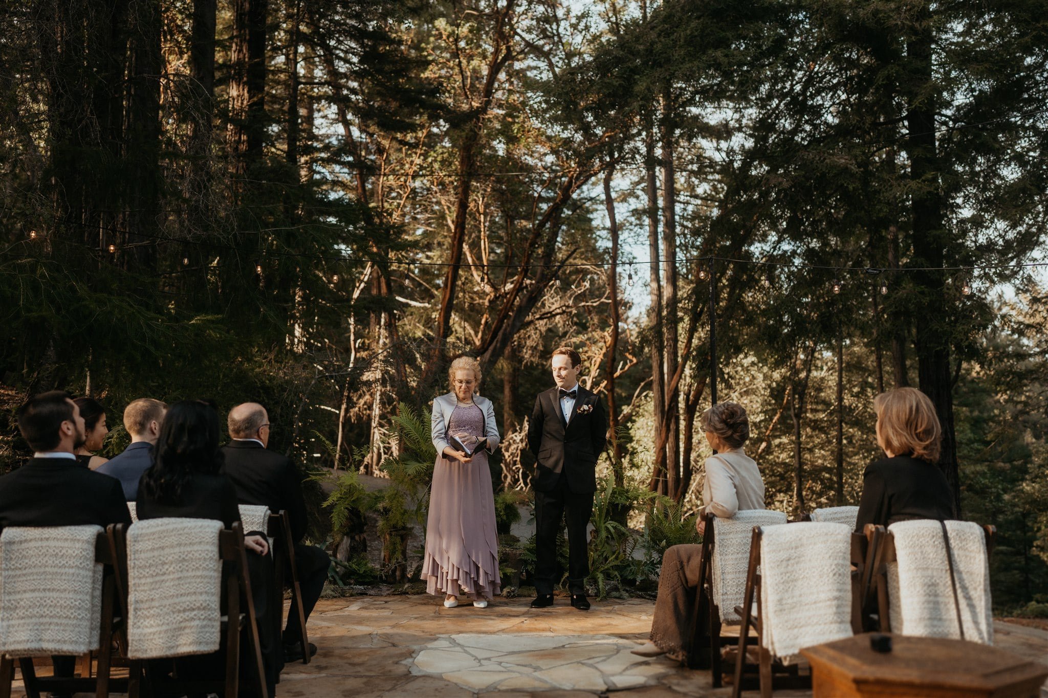 Groom waiting at the end of the aisle at winter wedding ceremony at Sequoia Retreat Center
