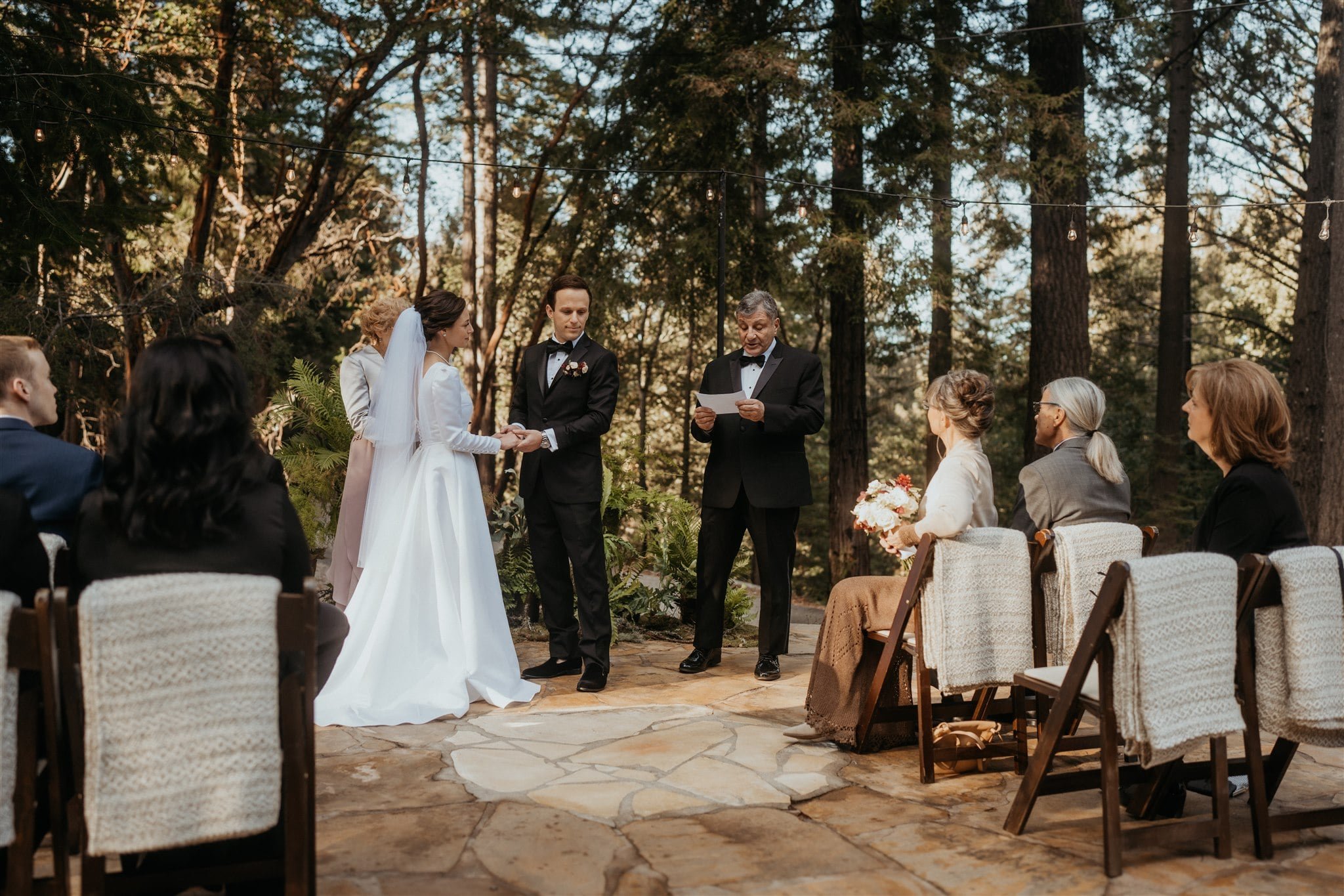 Bride and groom listen to father read during their California micro wedding ceremony at Sequoia Retreat Center