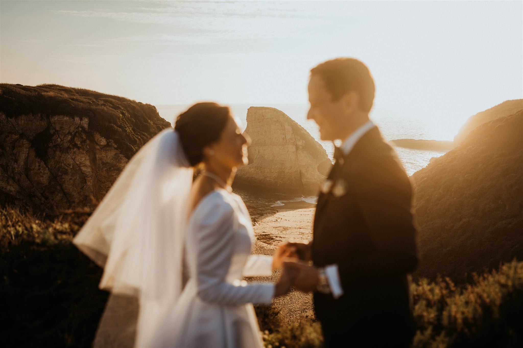 Bride and groom portraits on the beach at sunset