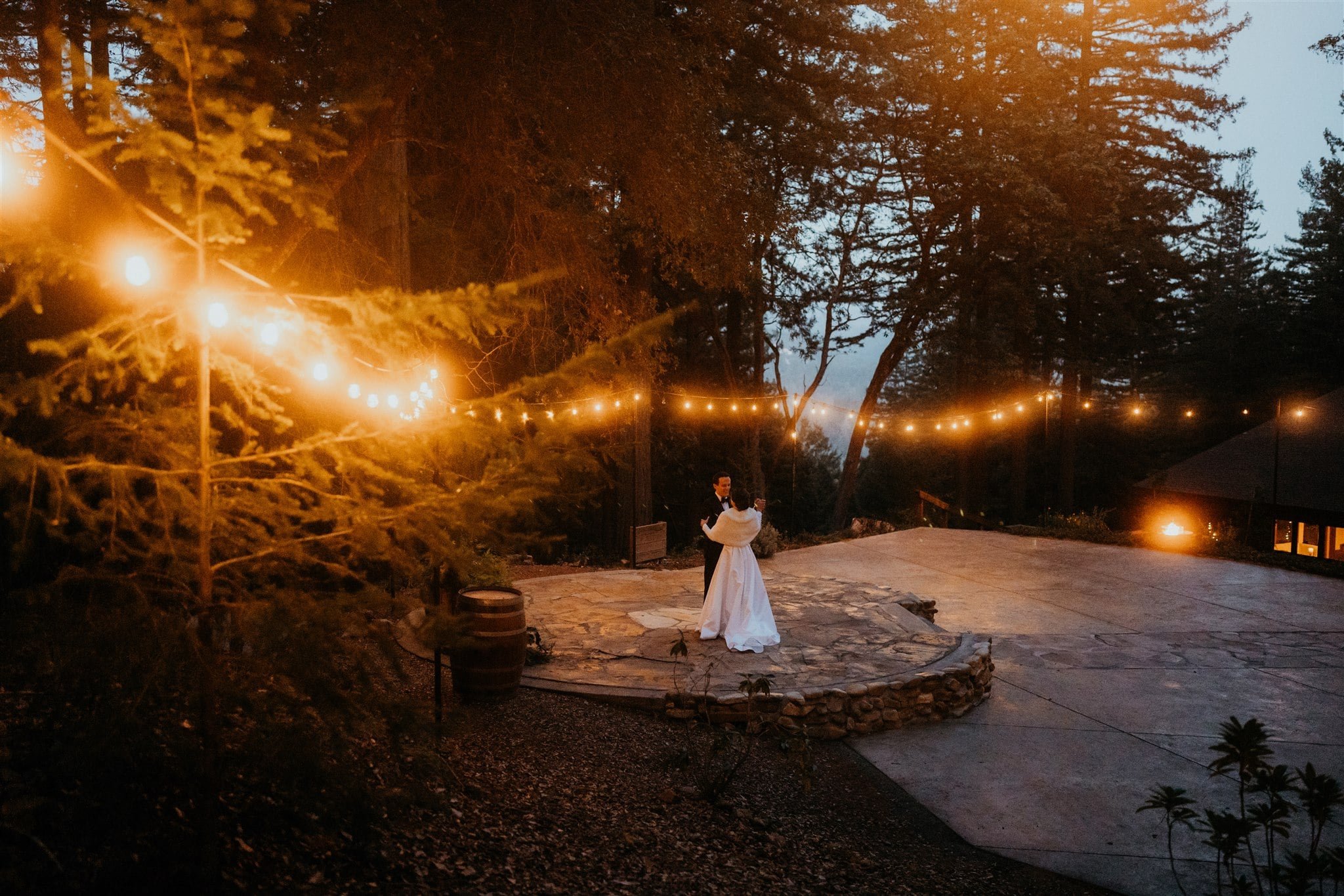 Bride and groom dance under twinkle lights at Sequoia Retreat Center