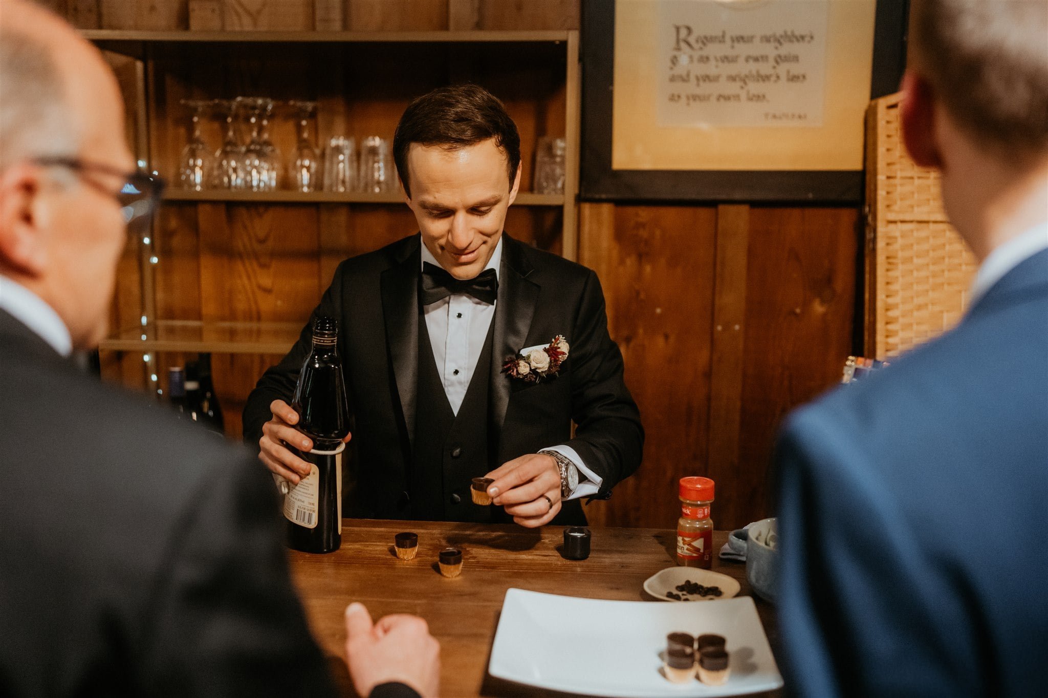 Groom makes craft cocktails at winter wedding reception in California