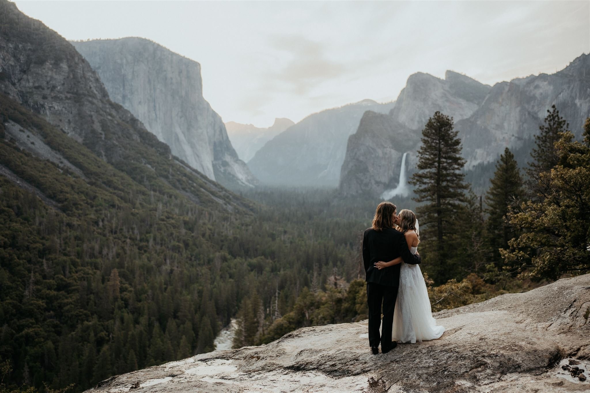Bride and groom hug during Tunnel View elopement in Yosemite