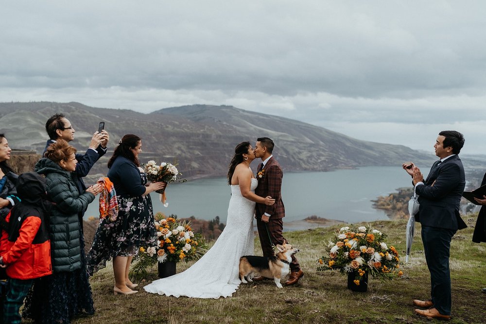 Bride and groom kiss during outdoor elopement ceremony at the Columbia River Gorge