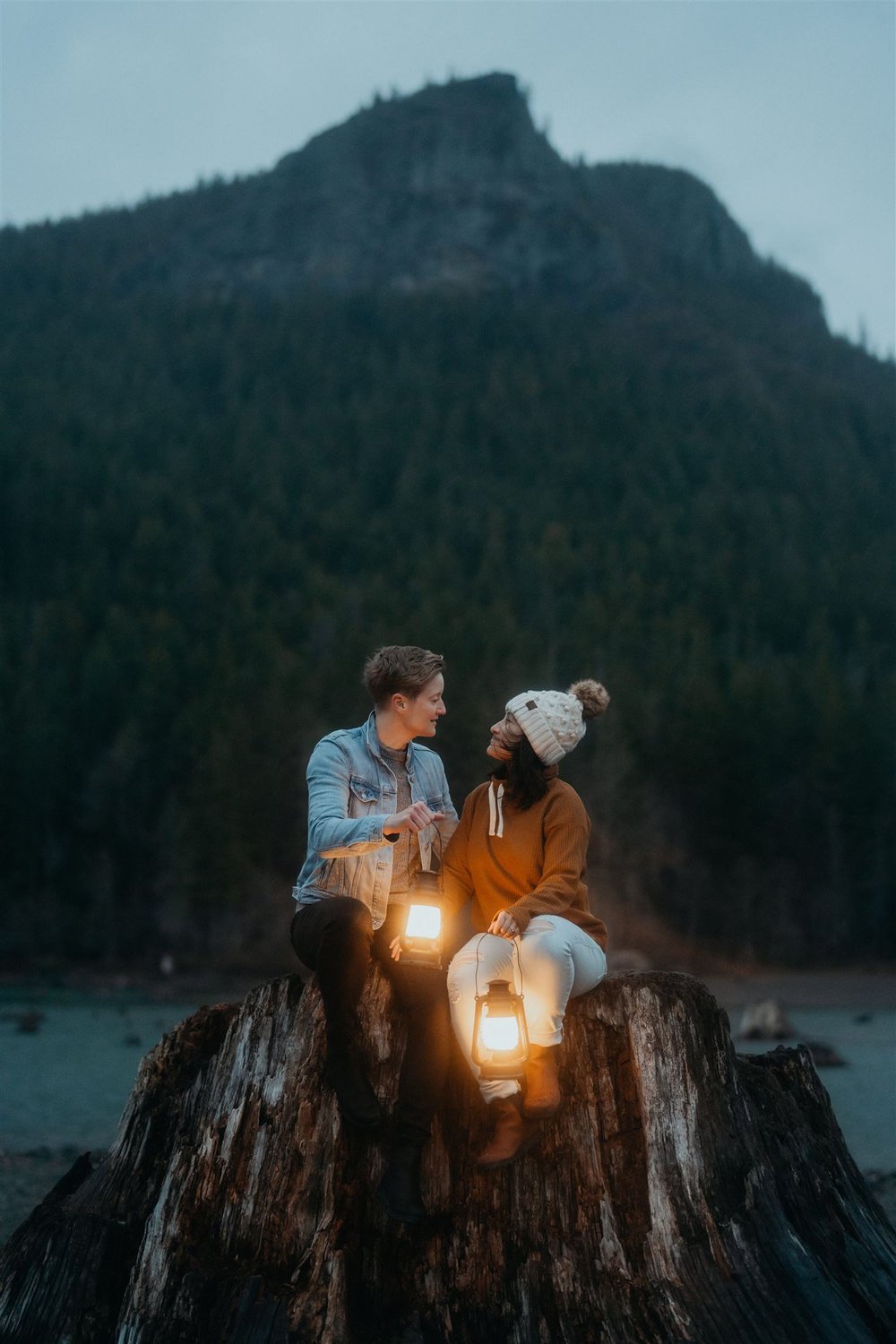 Couple sitting on a wood stump during their Snoqualmie Valley engagement photos