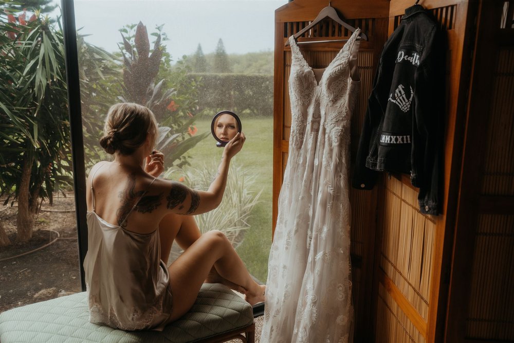 Bride doing her hair and makeup for her Hawaii elopement on the Big Island