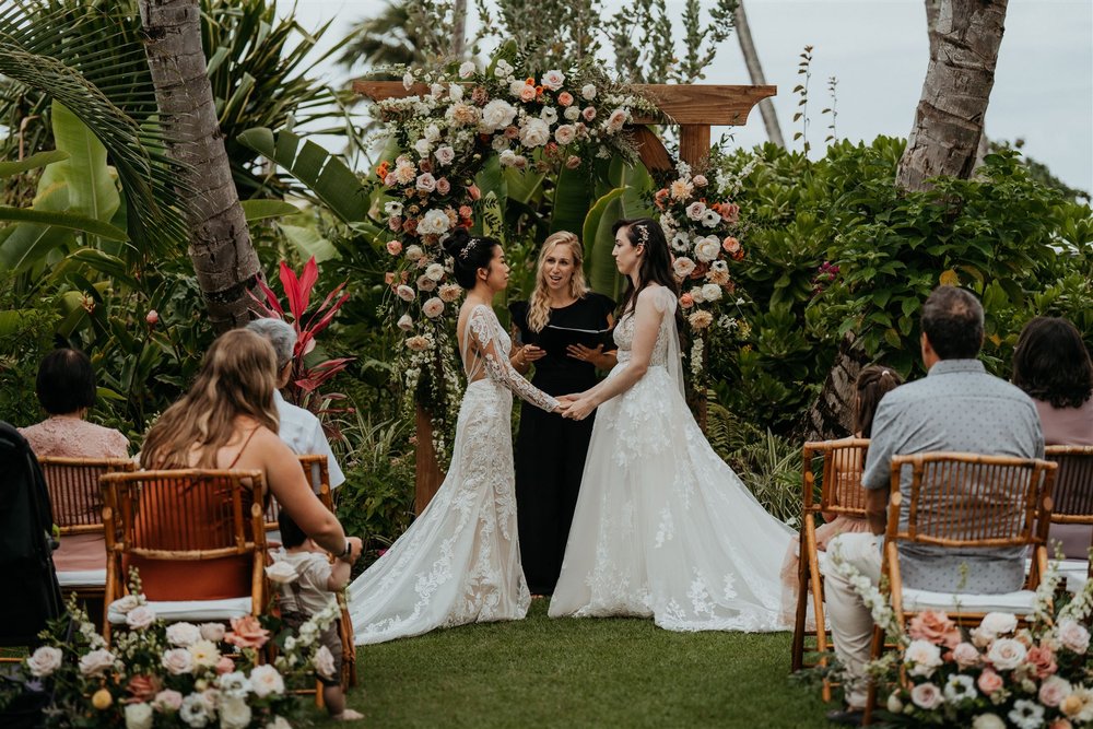 Hawaii elopement officiant overseeing a wedding ceremony in Oahu with two brides