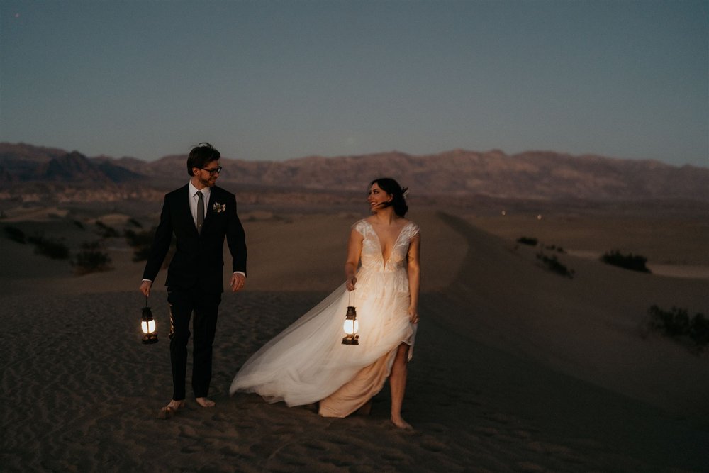 Bride and groom hold lanterns during their elopement in Death Valley National Park