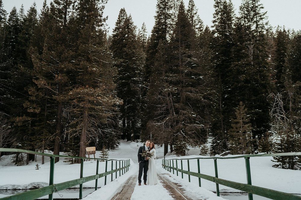 Bride and groom stand on a bridge during their Lake Tahoe elopement in California