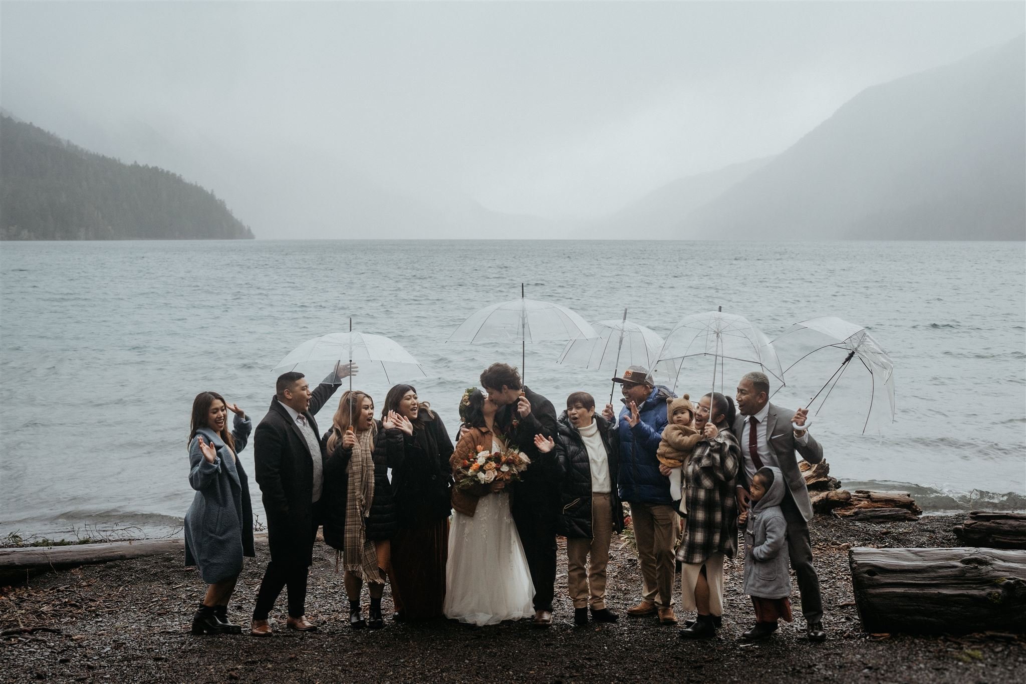 Bride and groom kiss during wedding party photos in Olympic National Park