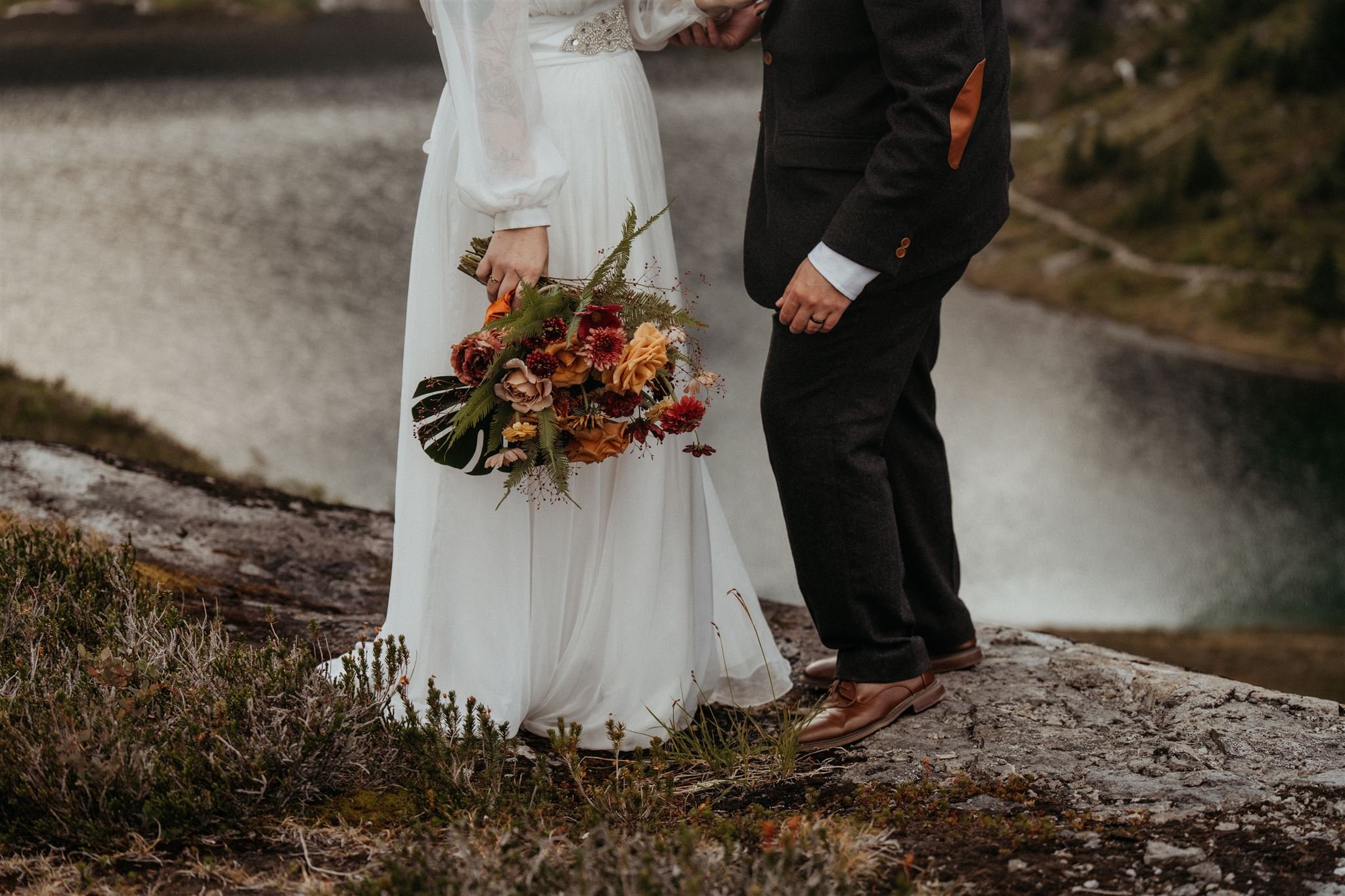 Bride holding bouquet by her side during couple photos at North Cascades elopement