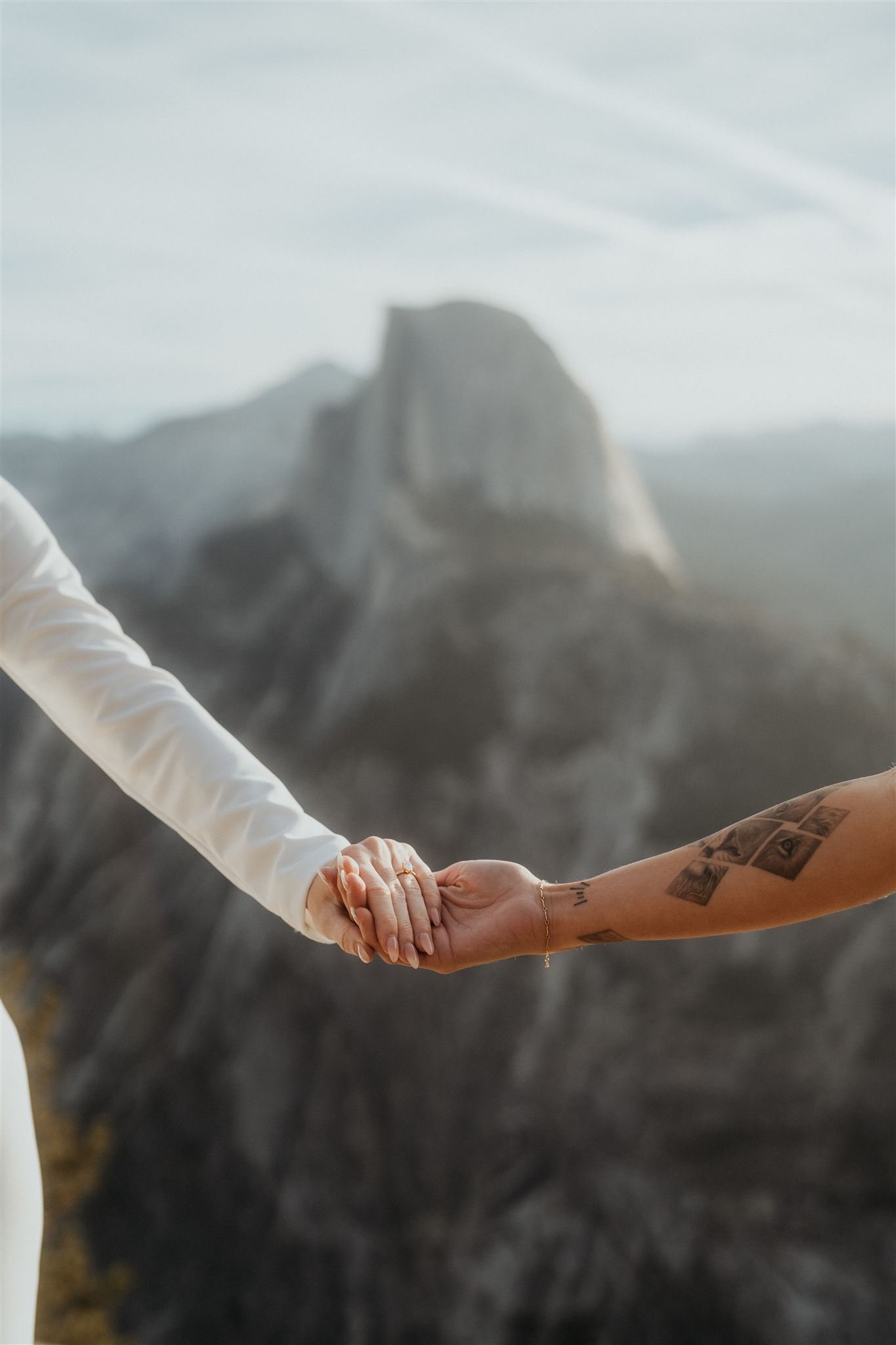 Brides holding hands at Glacier Point elopement