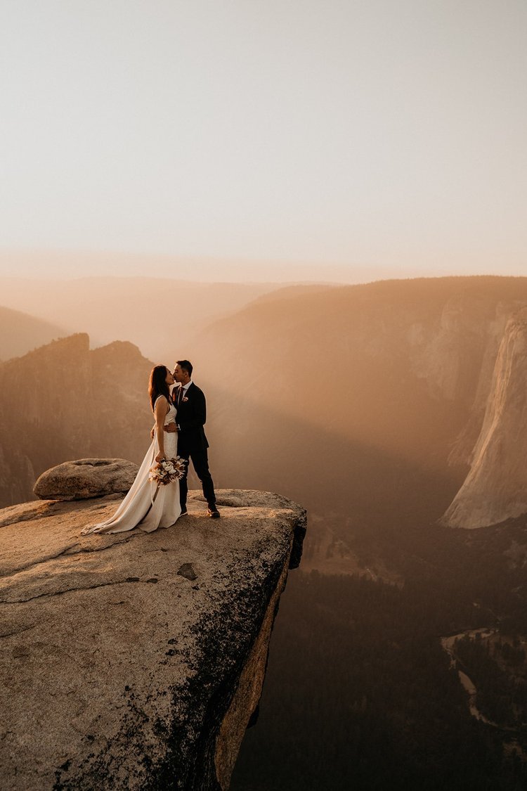 Bride and groom kiss at Taft Point during their Yosemite elopement