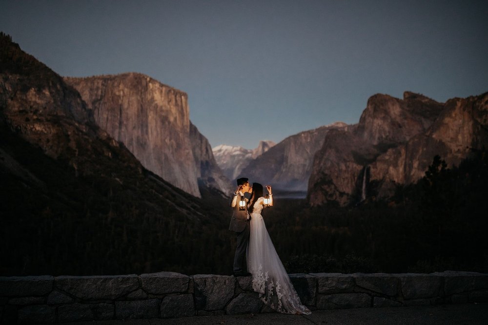 Bride and groom hold lanterns during sunset elopement at Yosemite