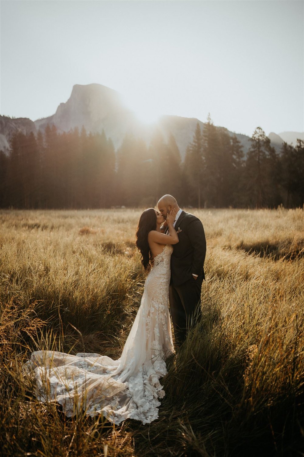 Bride and groom kiss in El Capitan Meadow at their Yosemite elopement