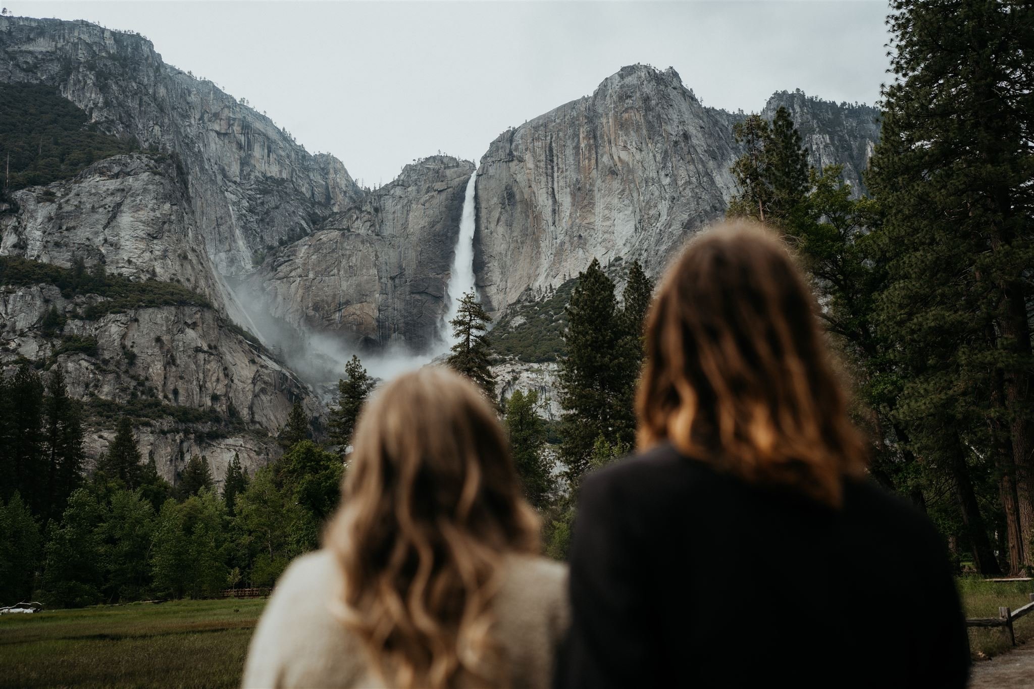 Bride and groom look out towards Yosemite Falls during their elopement in Yosemite National Park