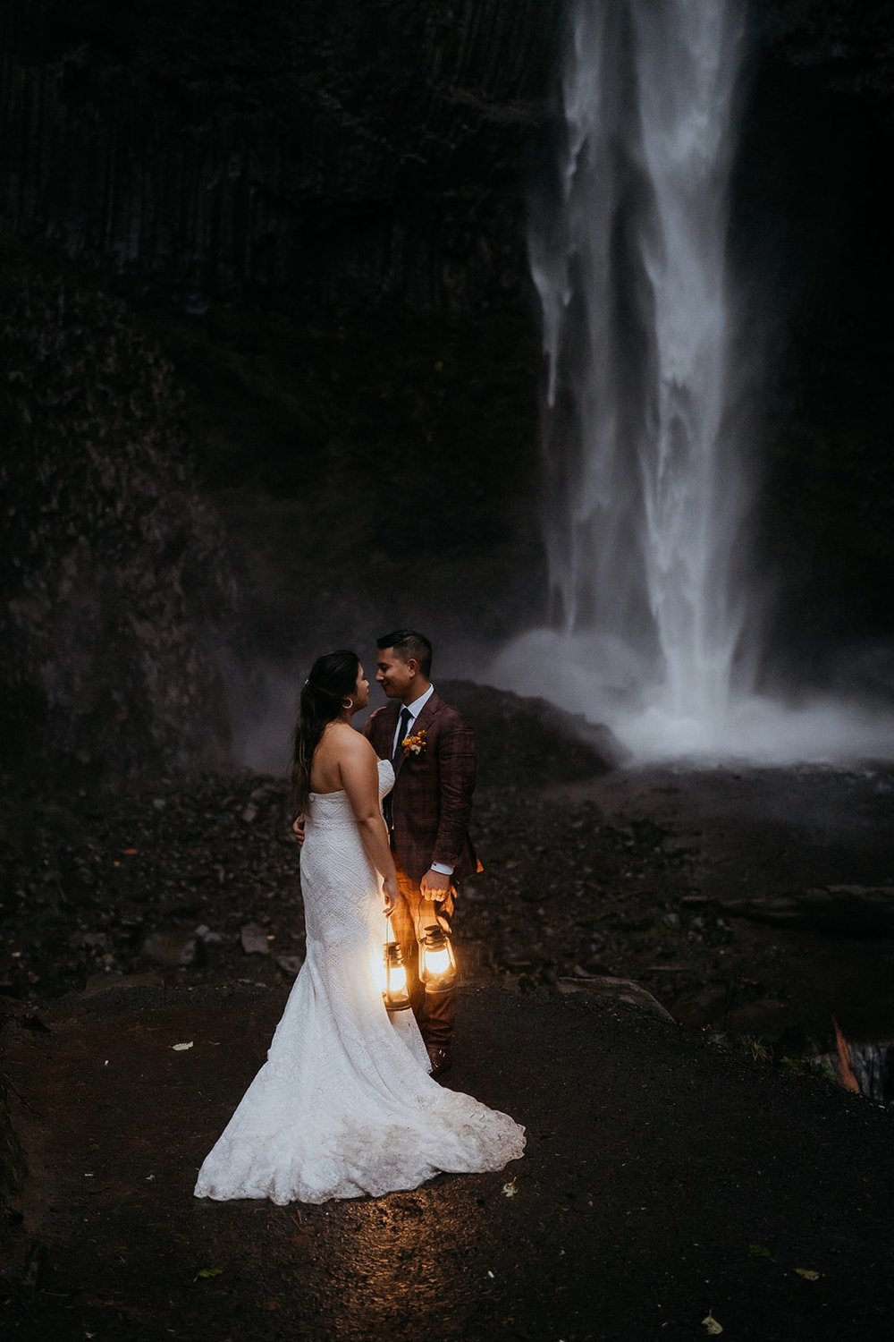 Bride and groom kiss during their blue hour waterfall elopement in Oregon