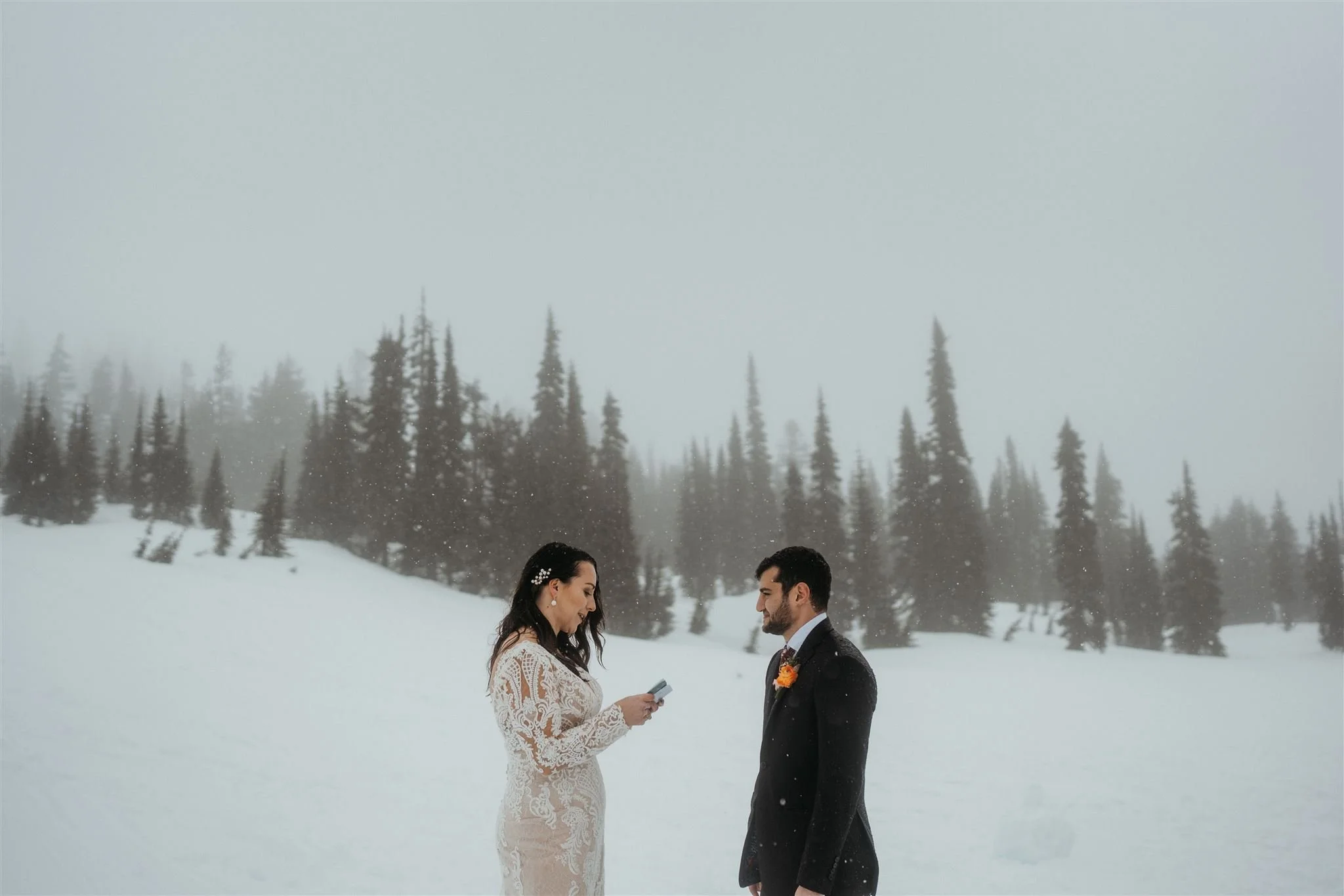 Bride and groom exchanging vows in the snowy mountains of Washington